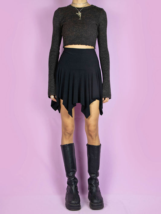 The Y2K Black Handkerchief Mini Skirt is a vintage black skirt with an asymmetrical pointed hem and elastic waistband. Fairy grunge goth 2000s party mini skirt.
