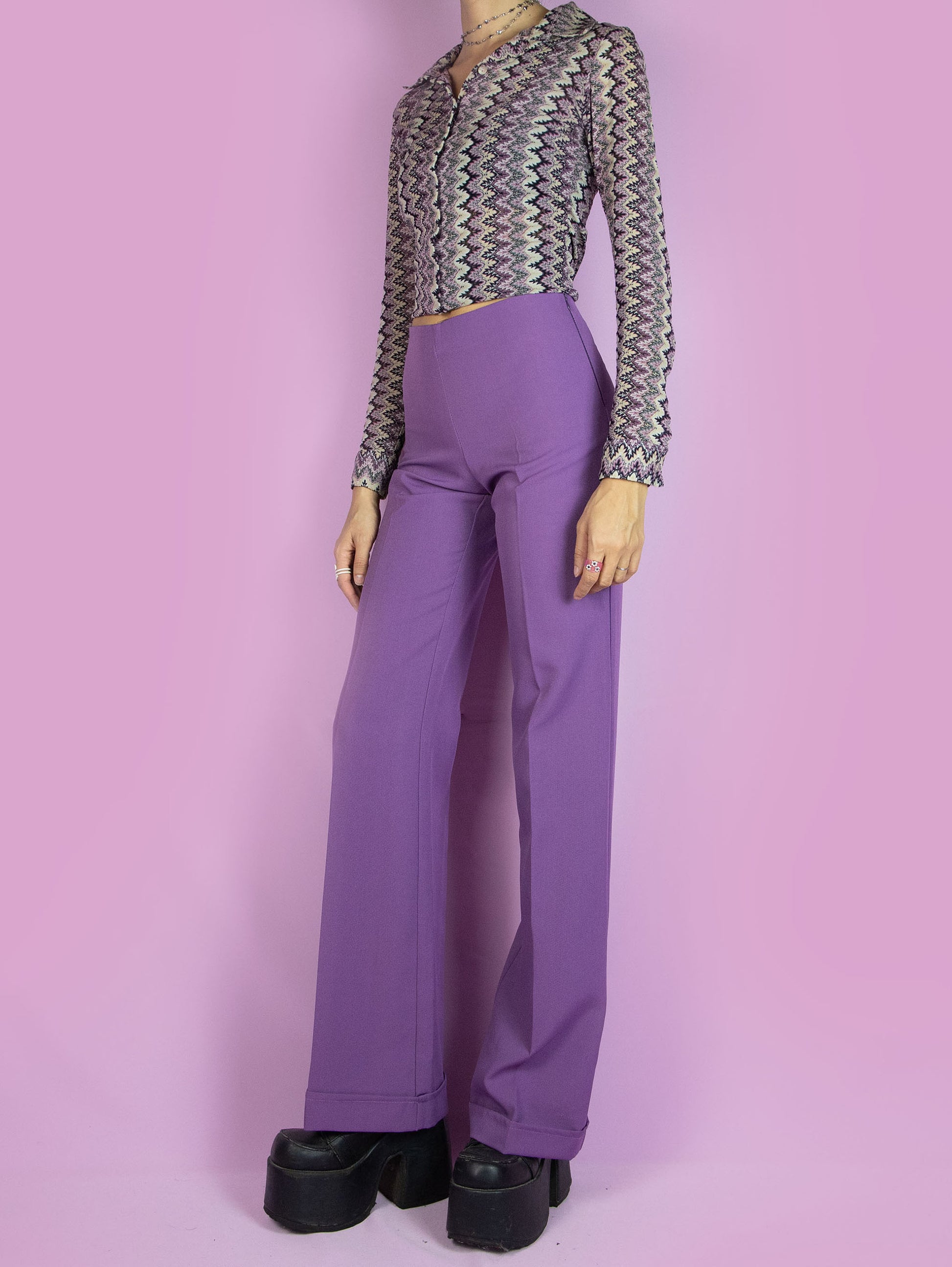 The Vintage 90s Purple Wide Trousers are high-waisted wide purple pants with a side zipper closure. Elegant tailored style 1990s classic pleated trousers.