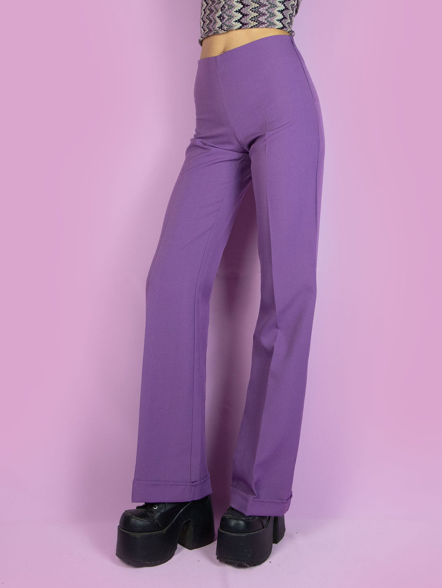 The Vintage 90s Purple Wide Trousers are high-waisted wide purple pants with a side zipper closure. Elegant tailored style 1990s classic pleated trousers.