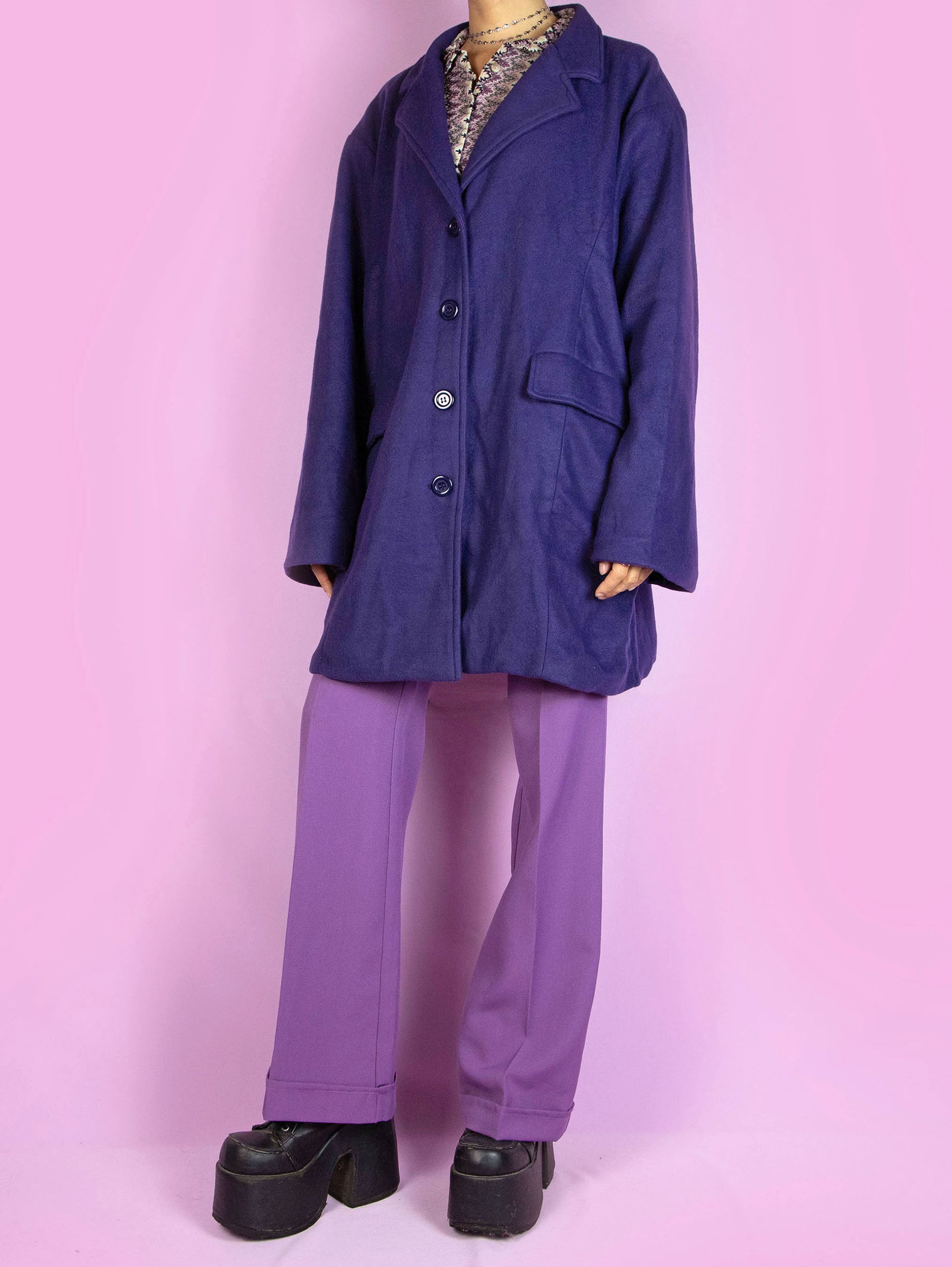 The Y2K Purple Blazer Jacket is a vintage dark purple blazer-style jacket with a collar, pockets, and buttons. Classic preppy 2000s office coat.