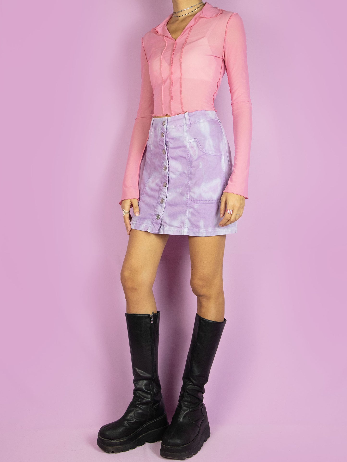 The Y2K Tie Dye Denim Mini Skirt is a vintage lilac and blue skirt with pockets and buttons. Cyber harajuku festival 2000s pastel purple bleached mini skirt.