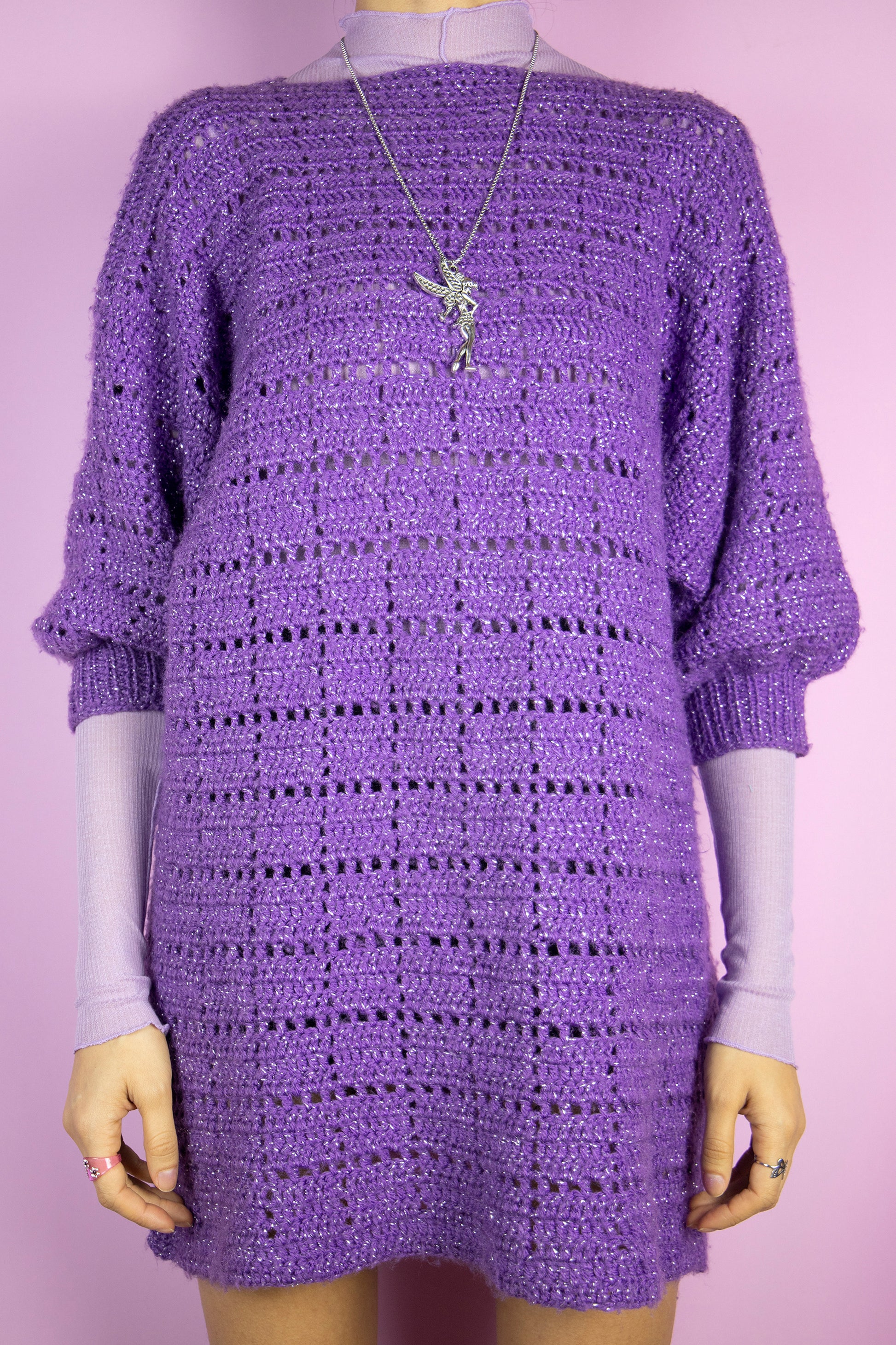 The Vintage 90s Purple Crochet Knit Sweater is a purple chunky knit short sleeve pullover with silver threads details. Lovely boho party 1990s statement sweater.
