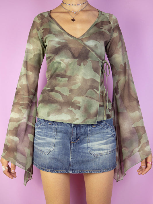 The Y2K Camouflage Mesh Top is a vintage green and brown camo print semi-sheer mesh wrap top with side tie detail and bell sleeves. Cyber grunge 2000s graphic shirt.
