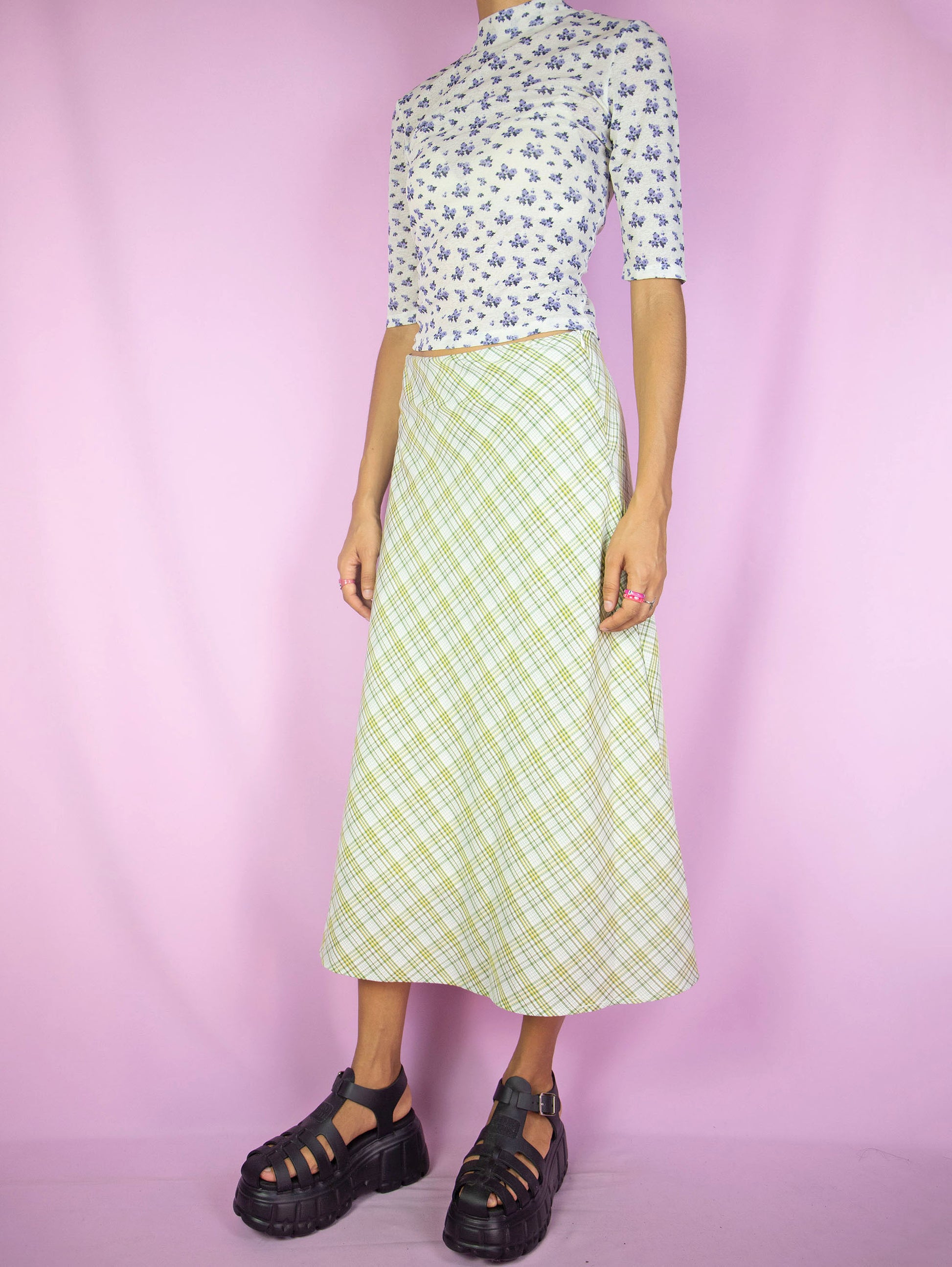 The Y2K Green Plaid Midi Skirt is a vintage flared beige yellow green plaid skirt with side zipper closure. Cottage prairie inspired 2000s boho preppy check maxi skirt.