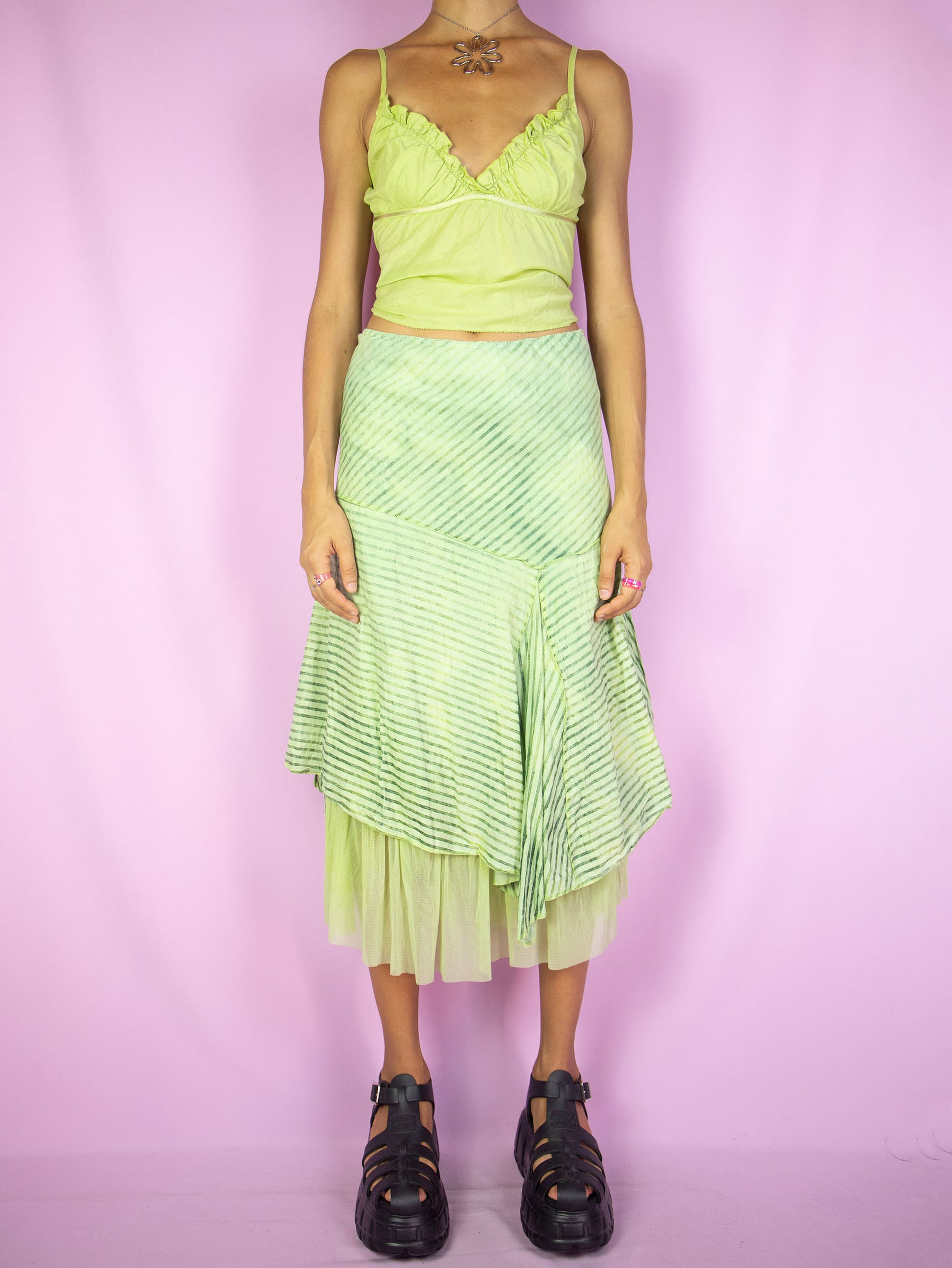 The Y2K Asymmetrical Layered Midi Skirt is a vintage 2000s cyber fairy festival party style green striped print skirt with pointed asymmetric layers, semi-sheer mesh hem and elastic waist.
