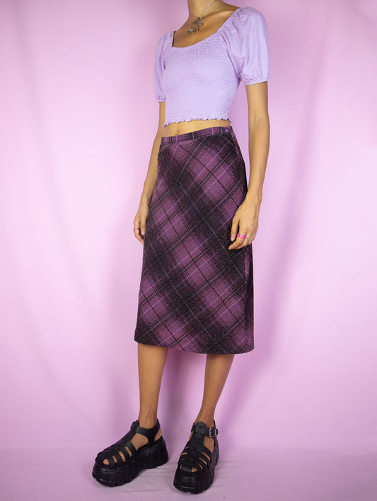 The Vintage 90s Purple Plaid Midi Skirt is a dark purple plaid skirt with side zipper closure. Dark academia preppy grunge 1990s check midi skirt.