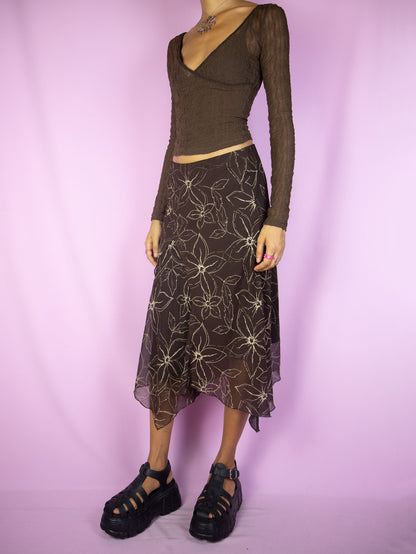 The Y2K Fairy Brown Midi Skirt is a vintage dark brown floral asymmetrical pointed skirt with elastic waist. Dark romantic whimsygoth 2000s grunge midi skirt.