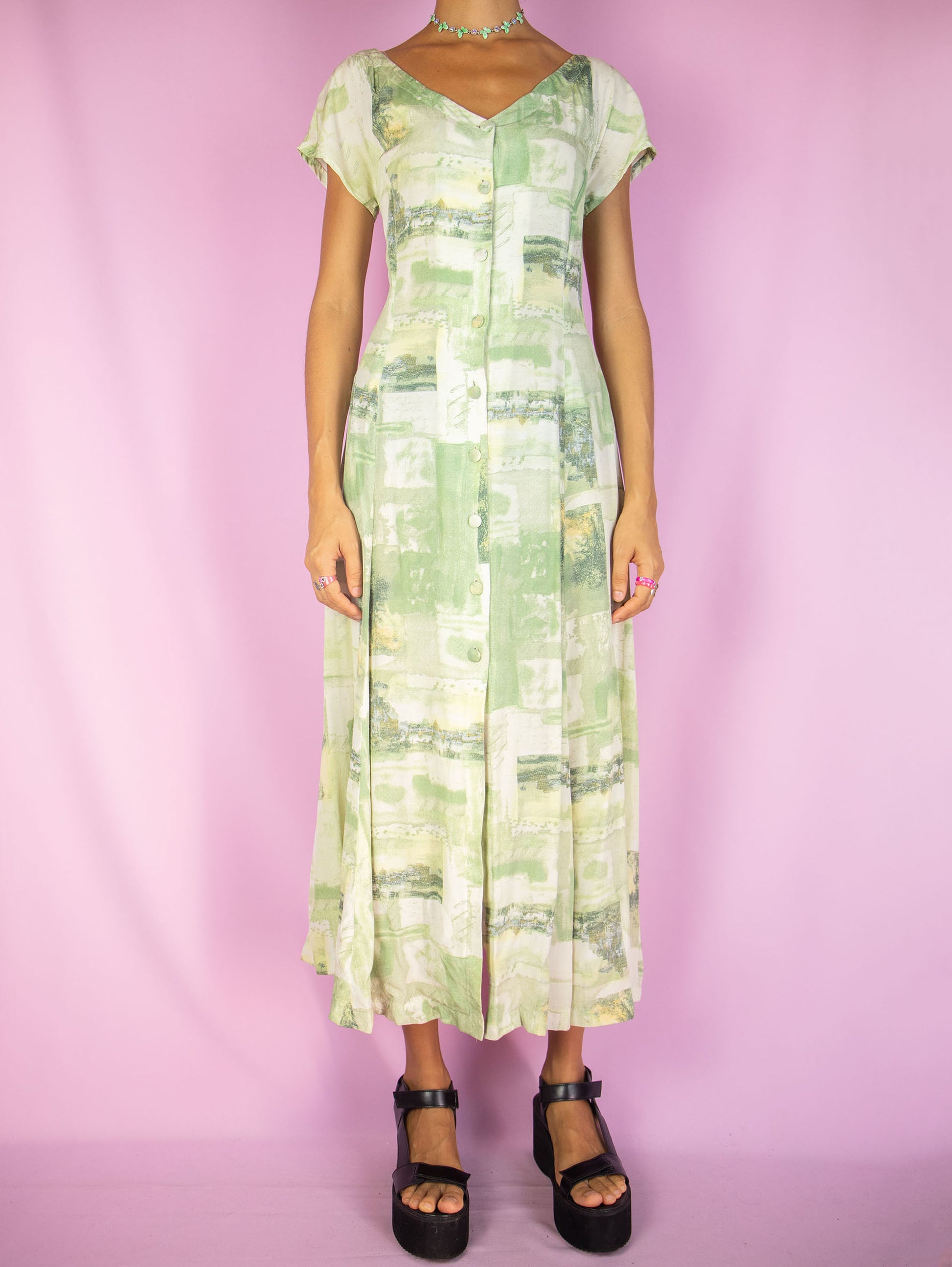 The Vintage 90s Boho Abstract Midi Dress is a green and white abstract short sleeve button down flared dress. Retro summer 1990s graphic maxi dress.