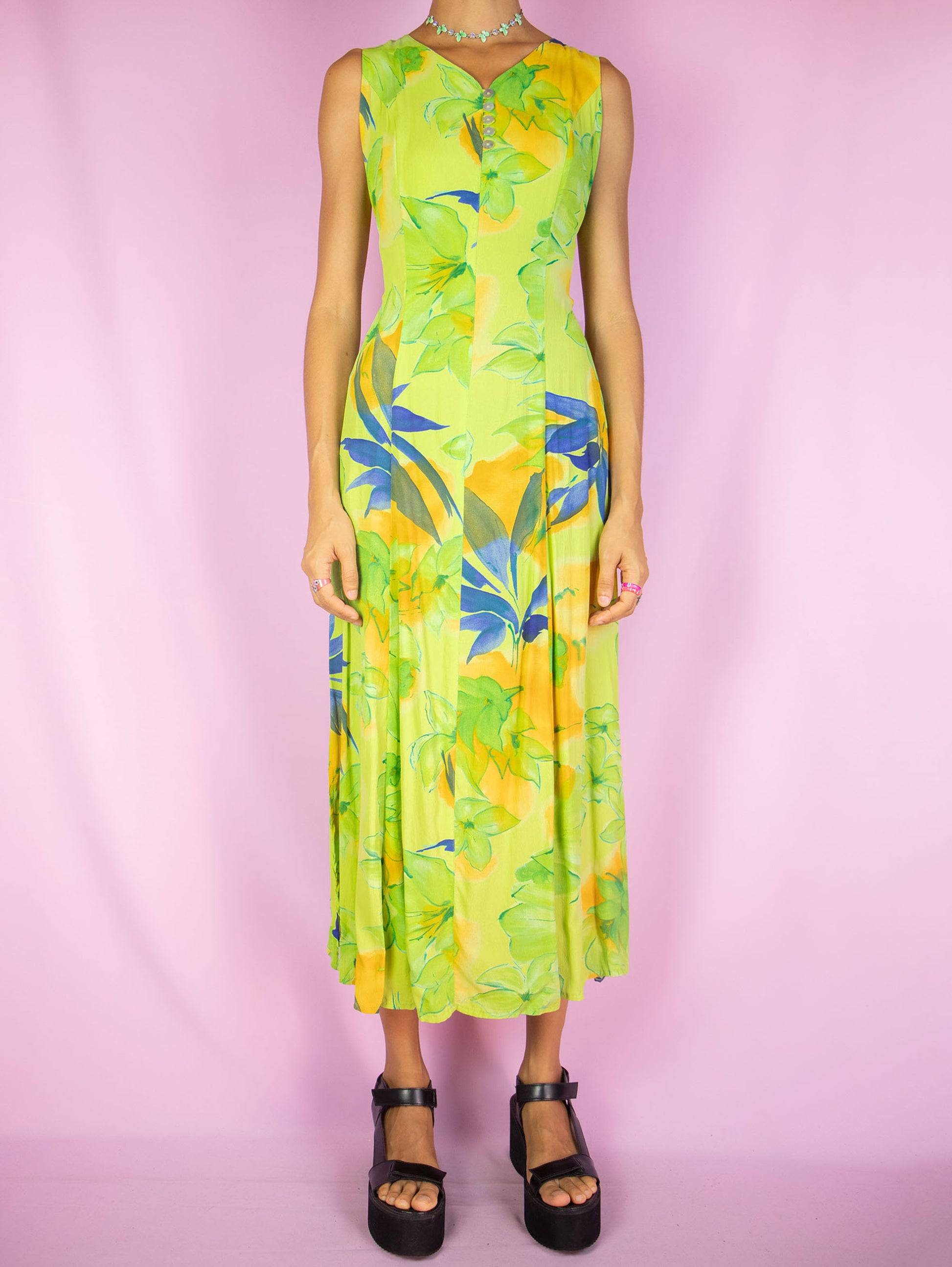 The Vintage 90s Boho Floral Midi Dress is a green multicolor floral sleeveless flared dress with side zipper closure and buttons down the front. Retro summer 1990s flowy maxi dress.