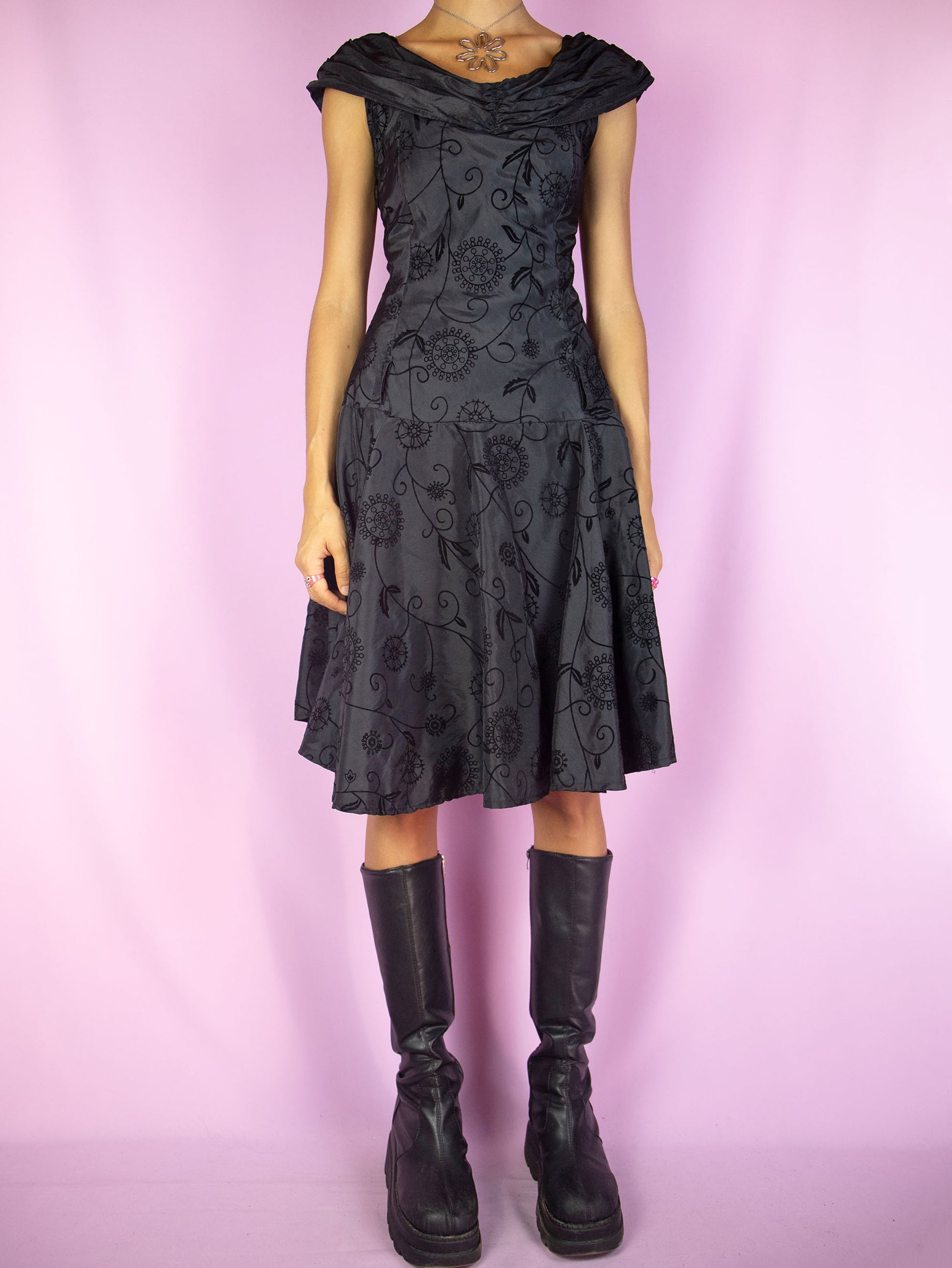The Vintage 90s Black Flare Midi Dress is a black sleeveless flared dress with floral velvet details and side zipper closure. Fairy grunge whimsygoth 1990S party night dress.