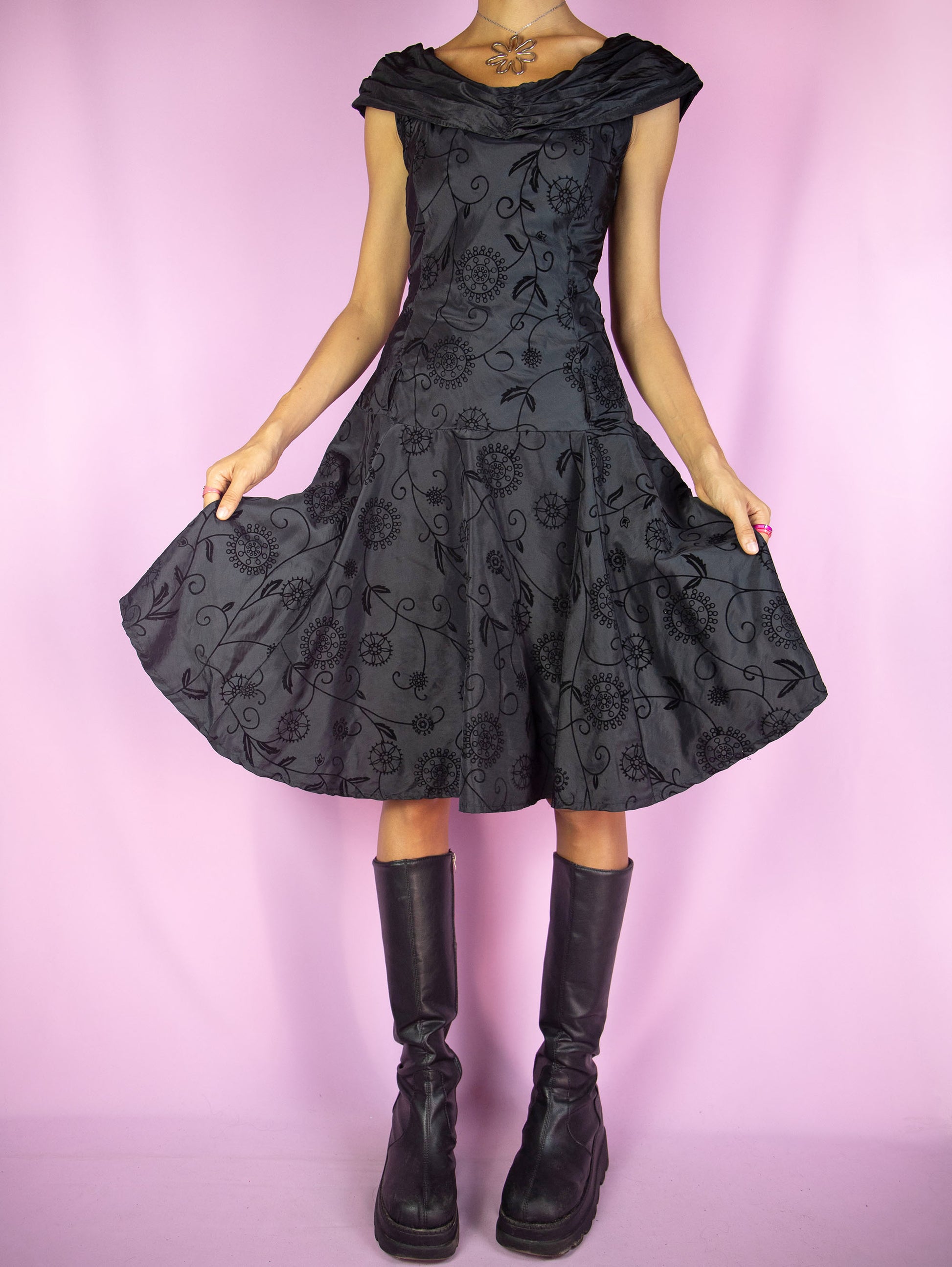 The Vintage 90s Black Flare Midi Dress is a black sleeveless flared dress with floral velvet details and side zipper closure. Fairy grunge whimsygoth 1990S party night dress.