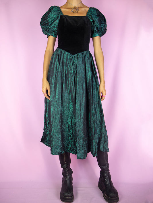 The Vintage 90s Puff Sleeve Midi Dress is an iridescent green flared dress with puff sleeves, black velvet front and back zipper closure. Cottage regency inspired 1990s dark romantic whimsygoth maxi dress.