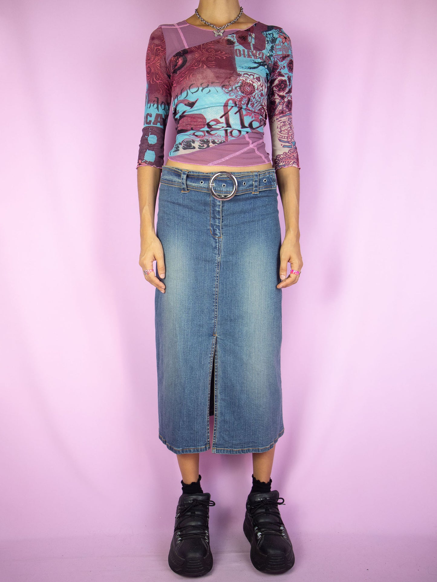 The Y2K Slit Denim Midi Skirt is a vintage stretch denim skirt with a front slit, belt buckle and zipper closure. Cyber grunge 2000s jean maxi skirt.