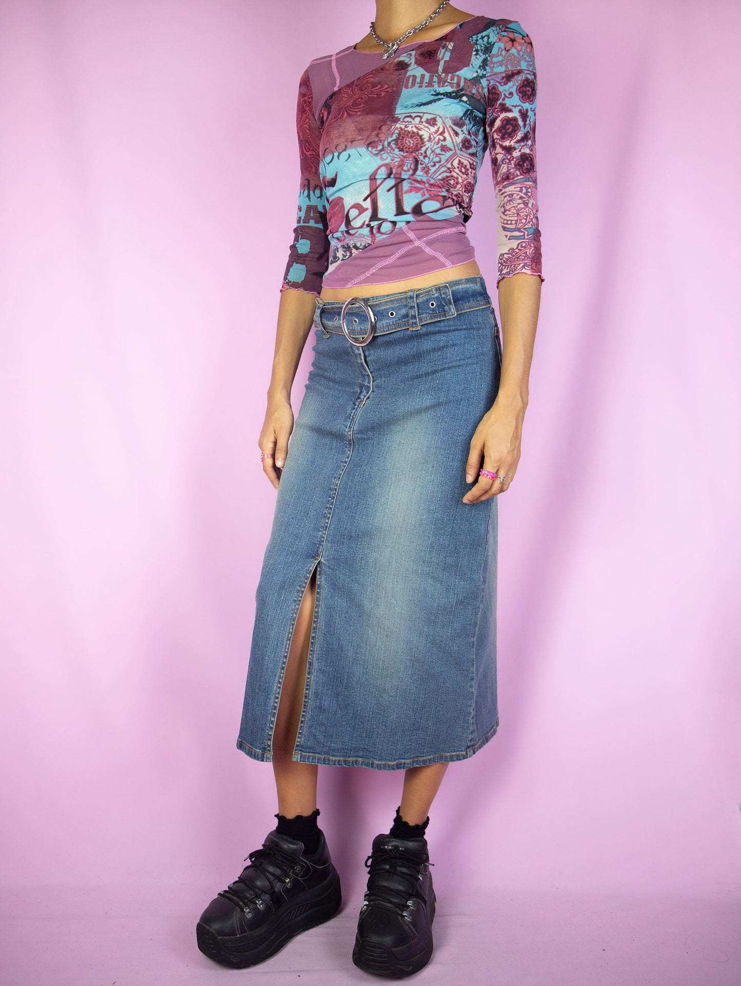The Y2K Slit Denim Midi Skirt is a vintage stretch denim skirt with a front slit, belt buckle and zipper closure. Cyber grunge 2000s jean maxi skirt.