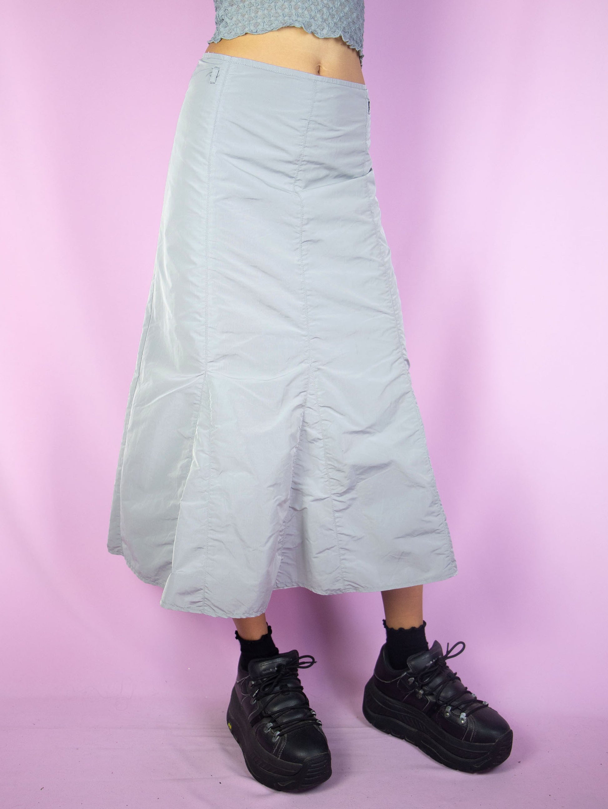 The Y2K Gray Parachute Midi Skirt is a vintage light gray paneled flared skirt with back zipper closure. Cyber goth grunge 2000s gorpcore subversive maxi skirt.