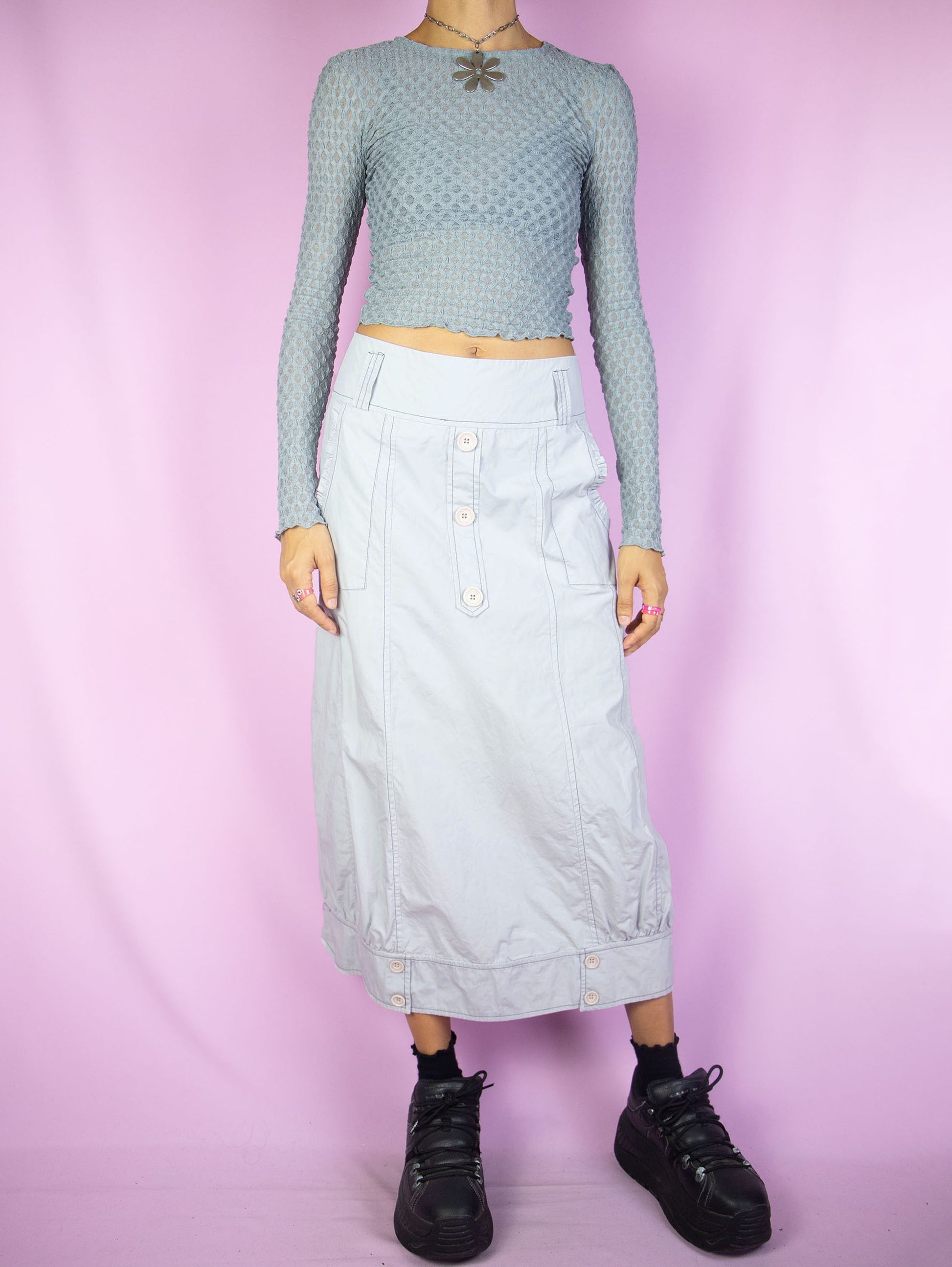 The Y2K Light Gray Midi Skirt is a vintage paneled light gray skirt with pockets and buttons and side zipper closure. Cyber goth gorpcore 2000s parachute cargo maxi skirt.