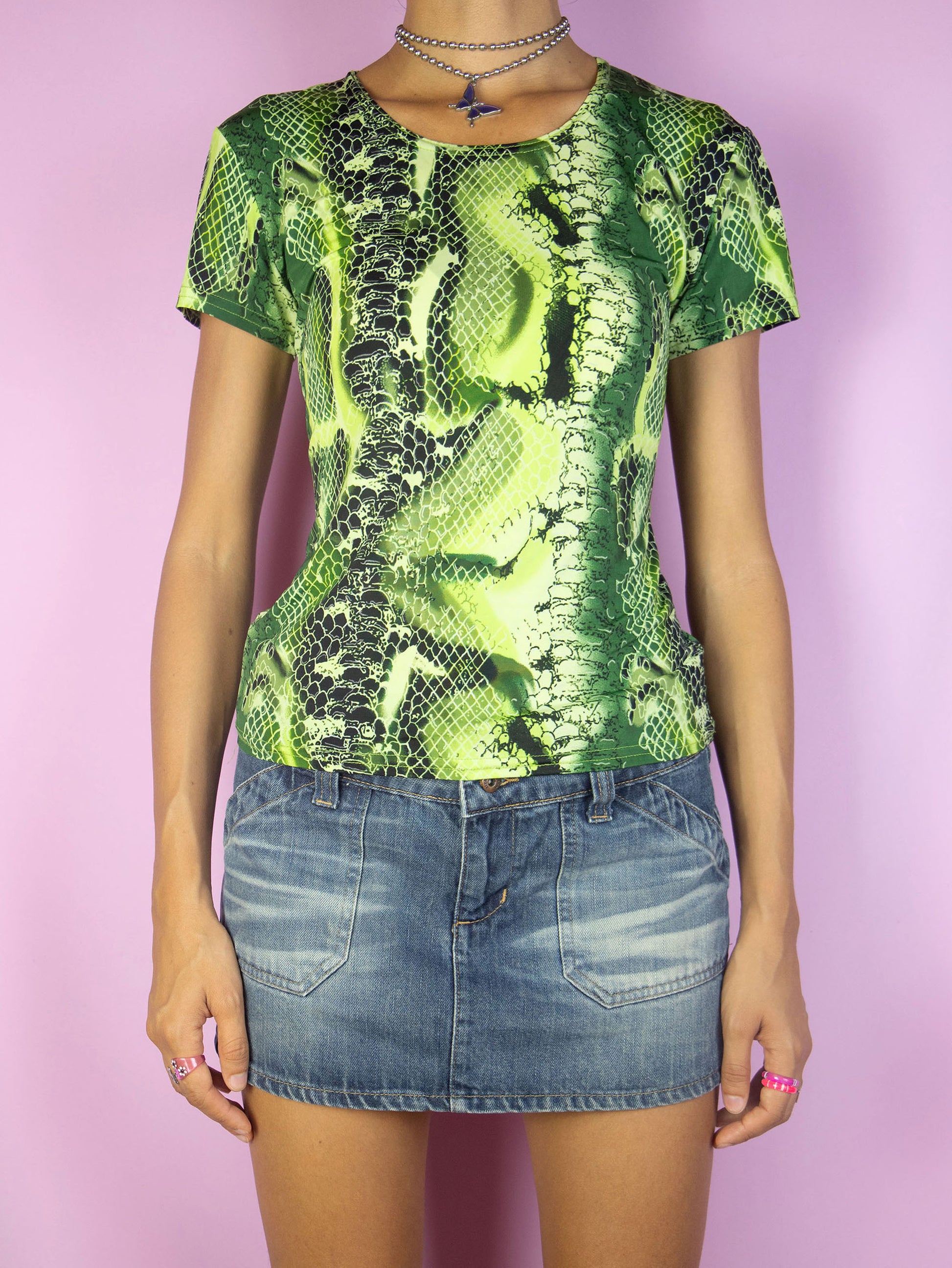 The Vintage 90s Green Snake Print Top is a short-sleeved green and black animal print graphic shirt. Cyber goth 1990s festival rave party top.