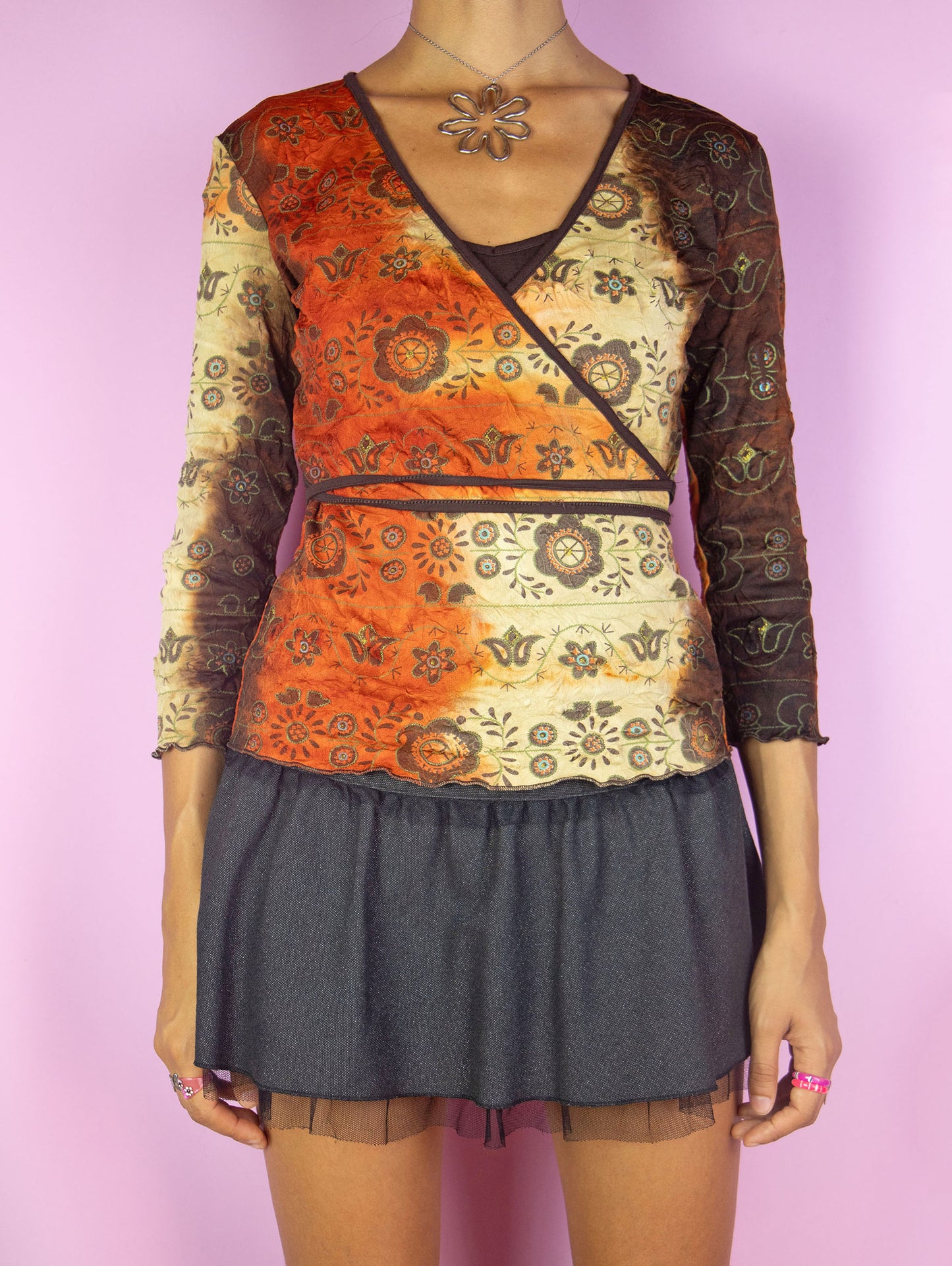 The Y2K Fairy Grunge Wrap Top is a vintage brown, orange and beige tie-dye wrap shirt with abstract floral print and three-quarter sleeves. Cyber boho 2000s side tie top.