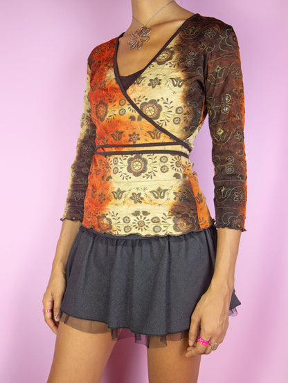 The Y2K Fairy Grunge Wrap Top is a vintage brown, orange and beige tie-dye wrap shirt with abstract floral print and three-quarter sleeves. Cyber boho 2000s side tie top.
