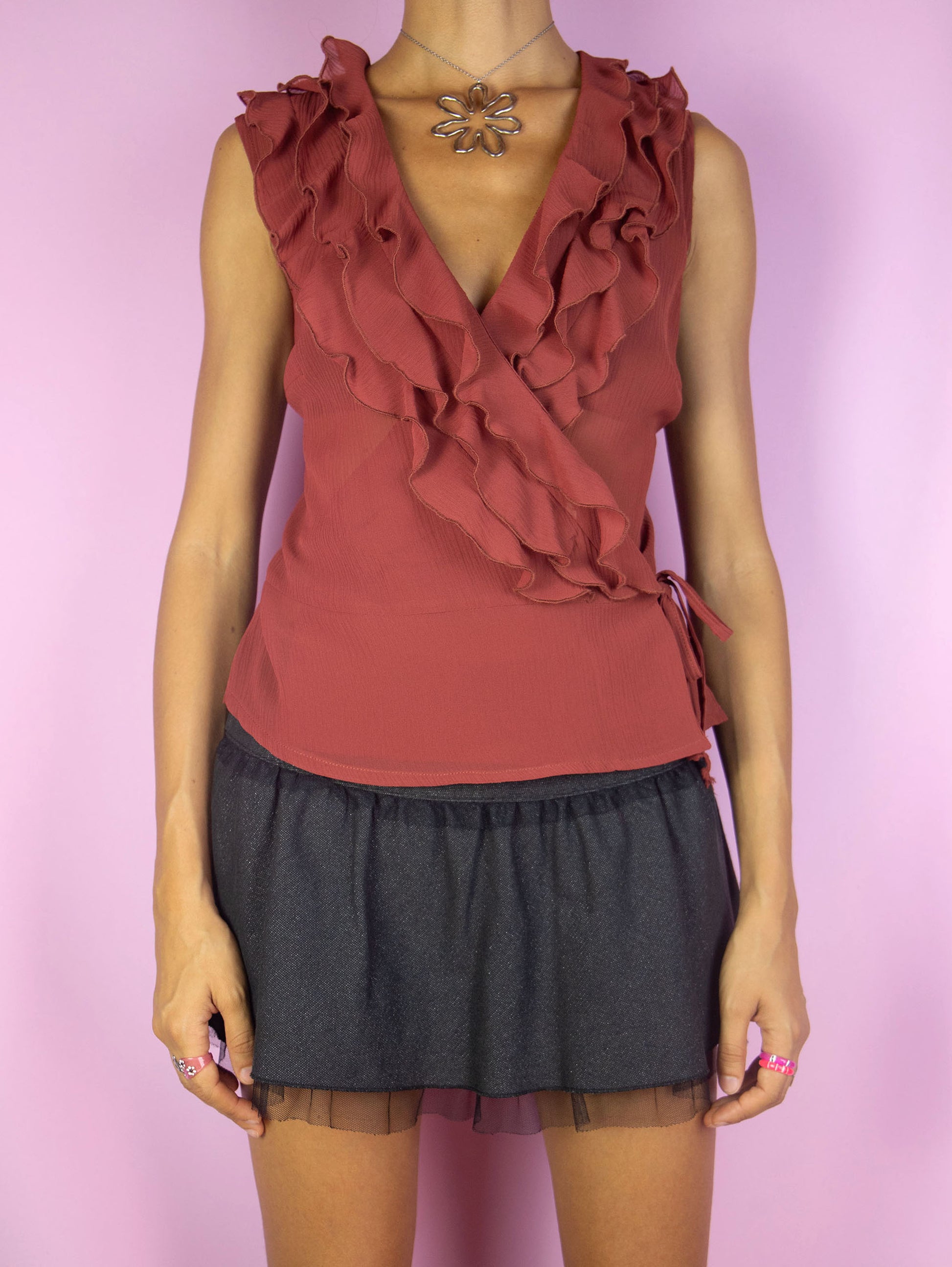 The Vintage 90's Maroon Ruffle Wrap Top is a semi-sheer terracotta maroon sleeveless side tied wrap top with a ruffle collar. Lovely avant garde romantic fairy grunge summer blouse circa 1990's.