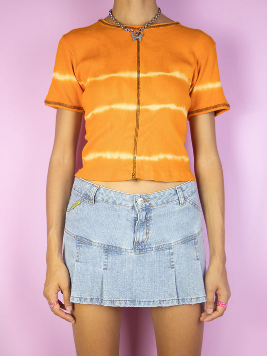 The Vintage Y2K Orange Tie Dye Top is a short sleeve ribbed orange t-shirt with bleached stripes. Super cute cyber grunge summer festival shirt circa 2000's.