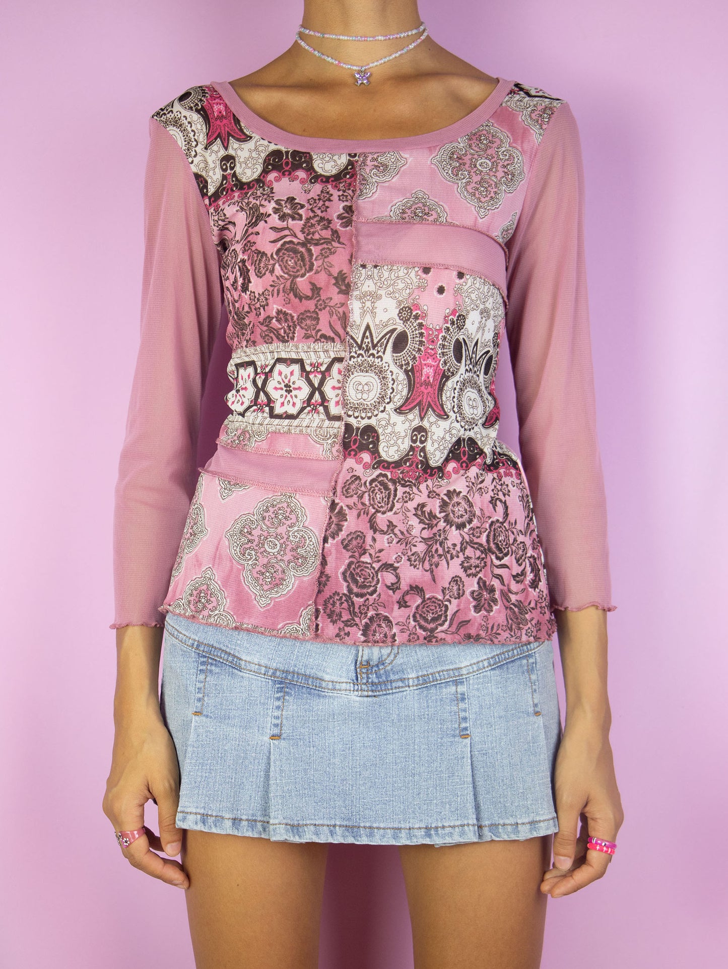 The Vintage Y2K Pink Abstract Mesh Top is a semi-sheer mesh lettuce hem multicolored pink paisley floral abstract print three-quarter sleeve t-shirt. Super cute cyber fairy grunge gorpcore shirt circa 2000's.