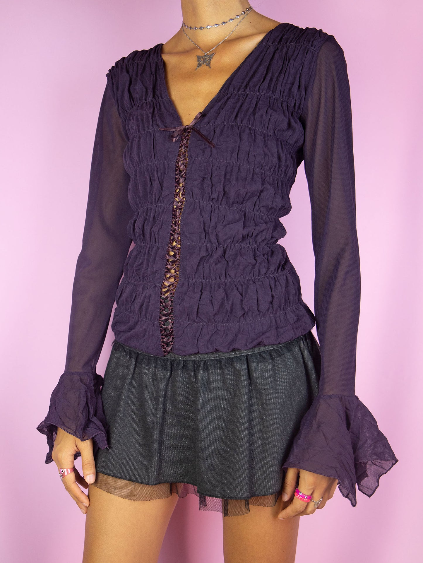 The Vintage Y2K Dark Purple Mesh Blouse is a long bell sleeve ruched semi-sheer mesh dark purple top with lace-up front. Gorgeous romantic fairy grunge whimsygoth shirt circa 2000's.
