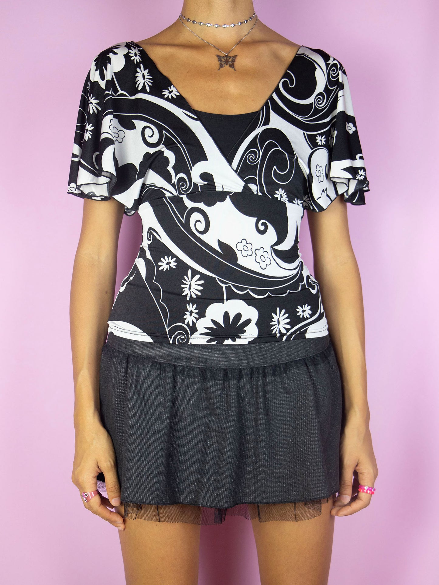 The Y2K Black Graphic Wrap Top is a vintage black and white abstract floral print short sleeve top. Cyber 2000s summer blouse.