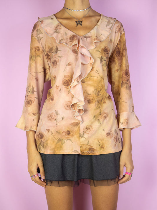 The Y2K Pink Floral Ruffle Top is a vintage rose gold three-quarter sleeve shirt with a ruffled collar and rose floral print. Super cute romantic cottage boho fairy grunge blouse from the 2000s.