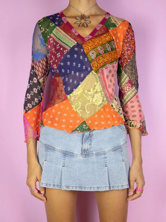 The Vintage 90s Boho Patchwork Sheer Top is an abstract floral multicolor three-quarter sleeve top made from scraps of various fabrics with lace details. Summer 1990s blouse.