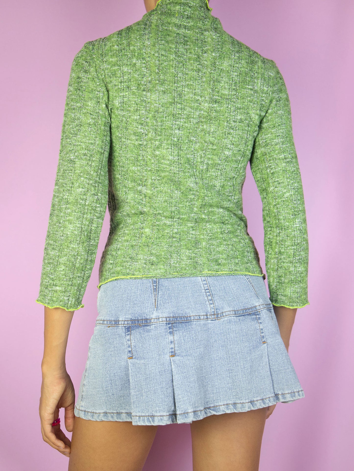 The Y2K Green Turtleneck Top is a vintage 2000s lightweight ribbed knit sweater with three-quarter sleeves.