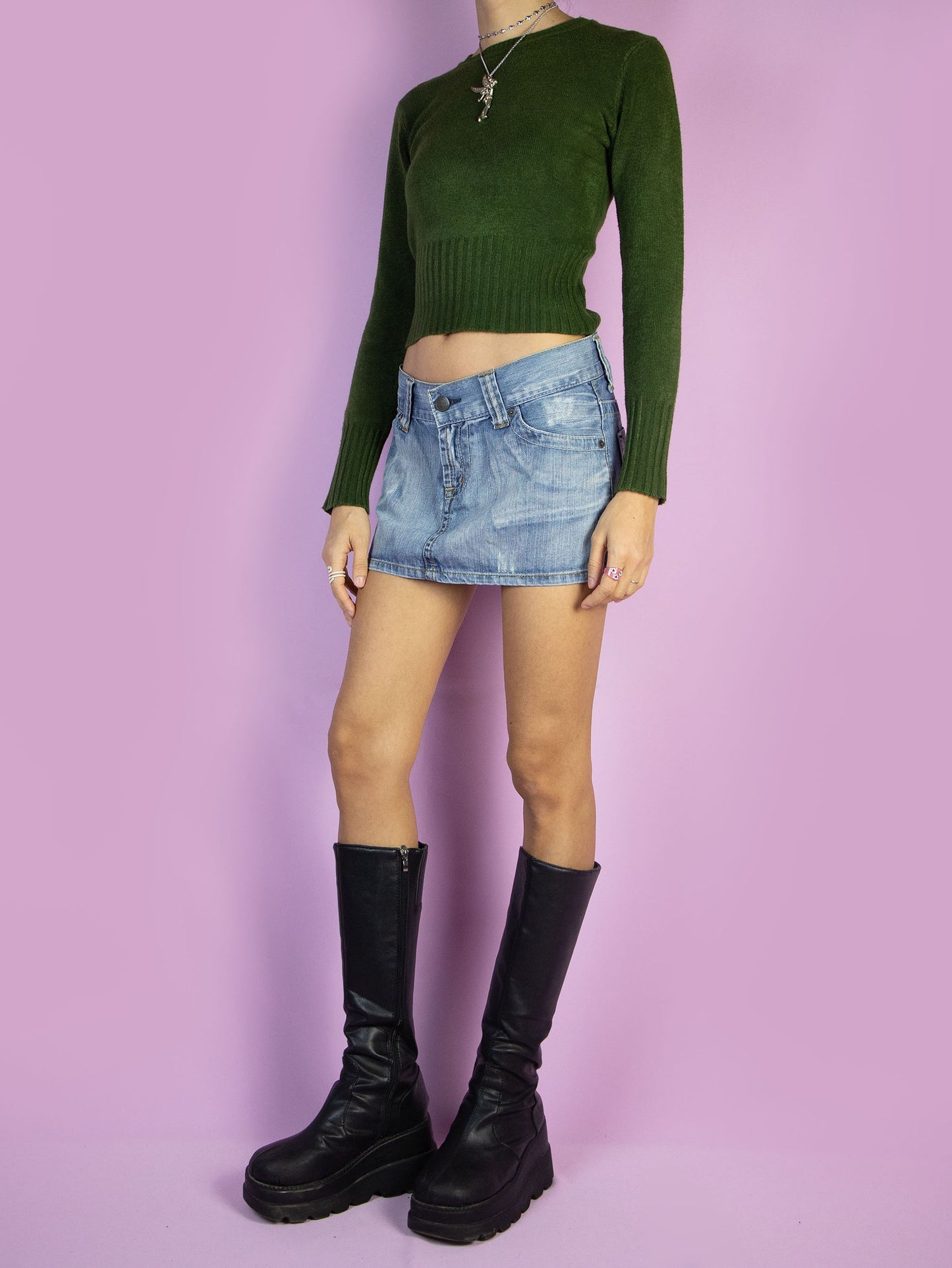 The Y2K Low Rise Denim Mini Skirt is a vintage low-waisted skirt with pockets and a zipper closure. Cyber grunge 2000s jean micro mini skirt.