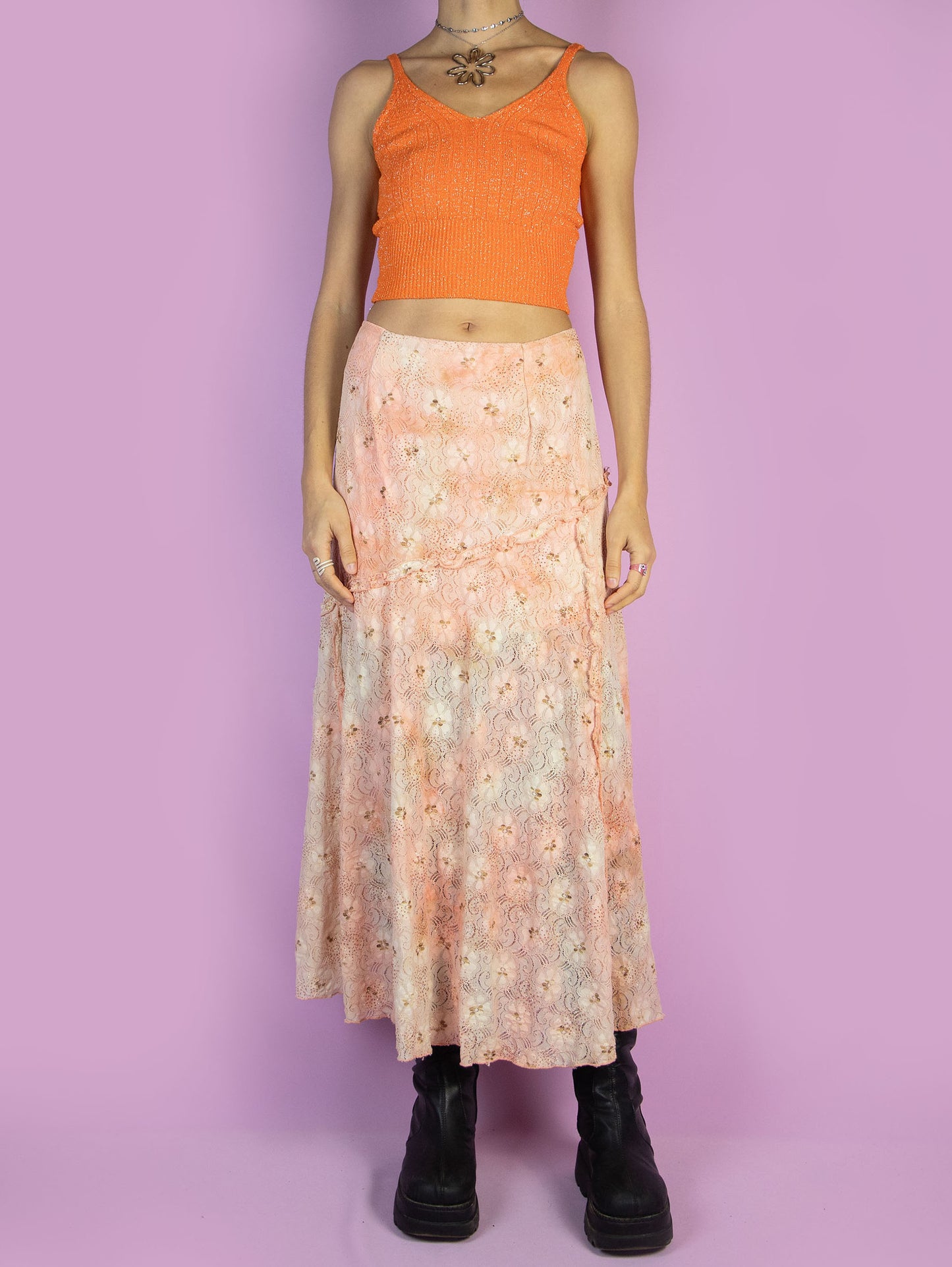 The Vintage 90s Fairy Orange Midi Skirt is a light orange and beige lace mesh skirt with glitter and ruffle details and a side zipper closure. Romantic boho 1990s pastel floral maxi skirt.