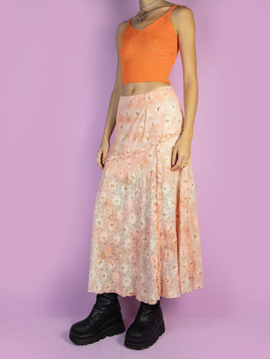 The Vintage 90s Fairy Orange Midi Skirt is a light orange and beige lace mesh skirt with glitter and ruffle details and a side zipper closure. Romantic boho 1990s pastel floral maxi skirt.