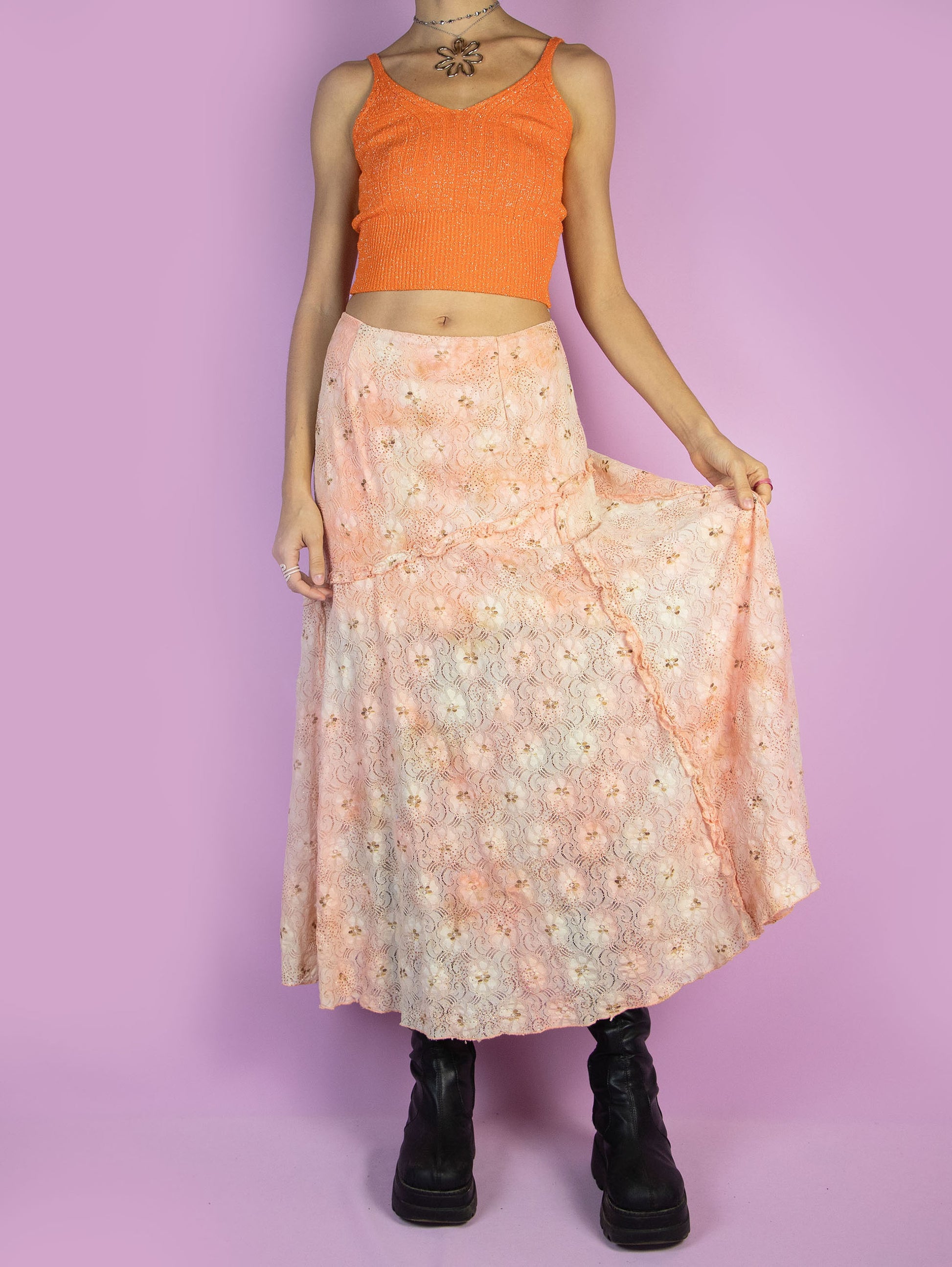 The Vintage 90s Fairy Orange Midi Skirt is a light orange and beige lace mesh skirt with glitter and ruffle details and a side zipper closure. Romantic boho 1990s pastel floral maxi skirt.