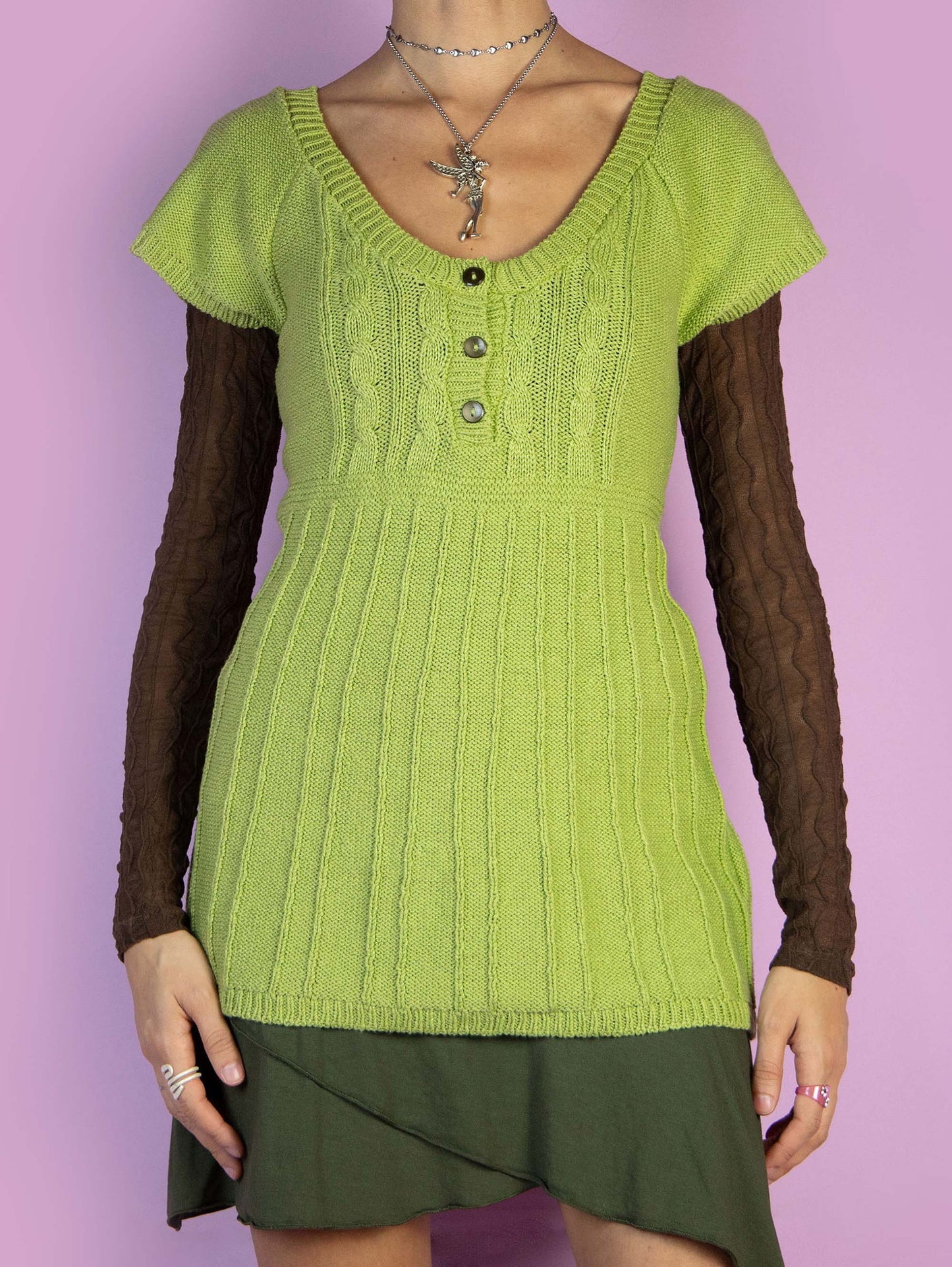 The Y2K Fairy Grunge Green Sweater is a vintage short-sleeved green jumper with a three-button detail. Cyber boho 2000s knitted pullover.
