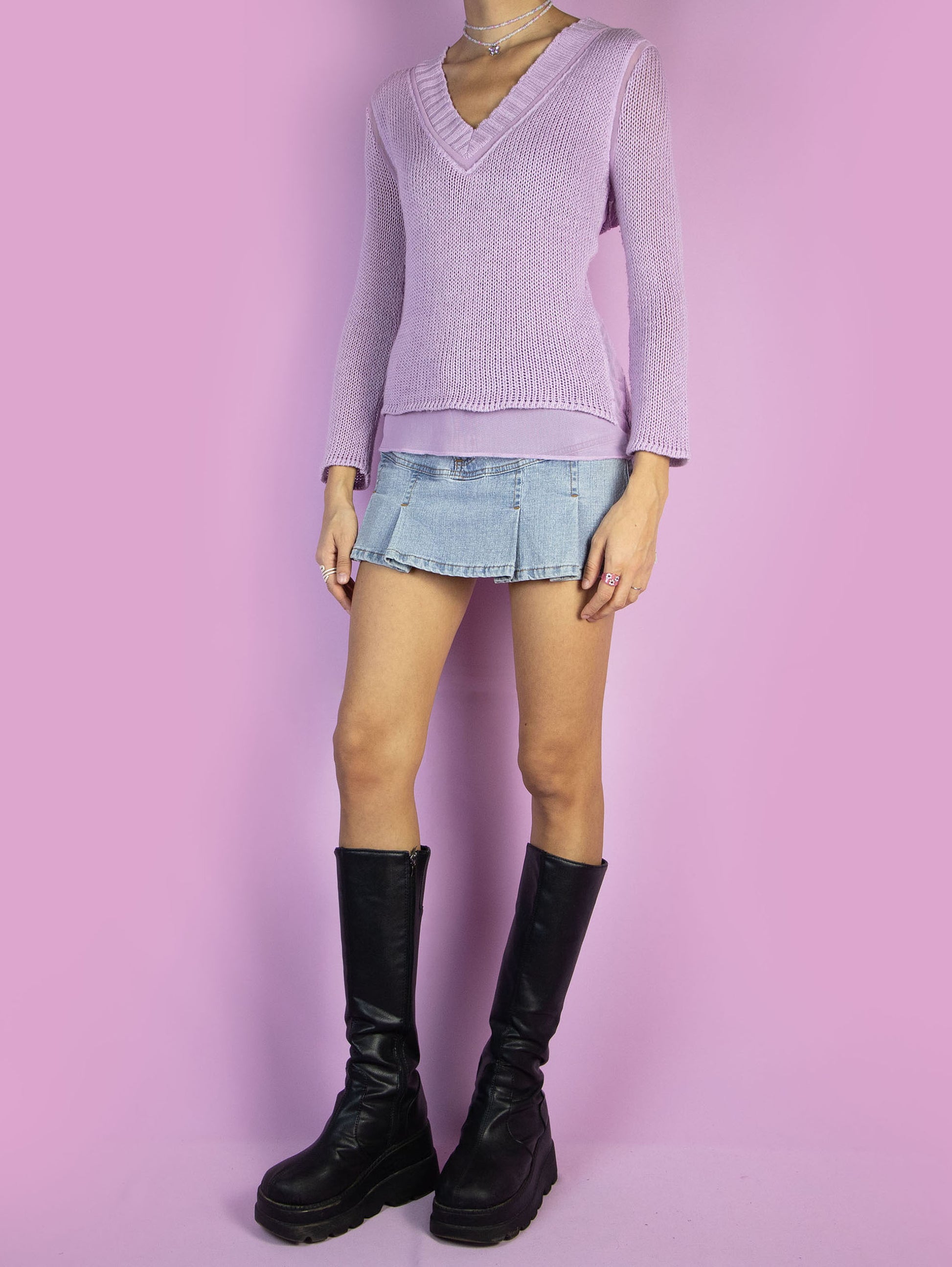The Y2K Pastel Purple Knit Sweater is a vintage light pinkish-purple sweater with a V-neck and mesh details. Cyber fairy grunge 2000s knit jumper.