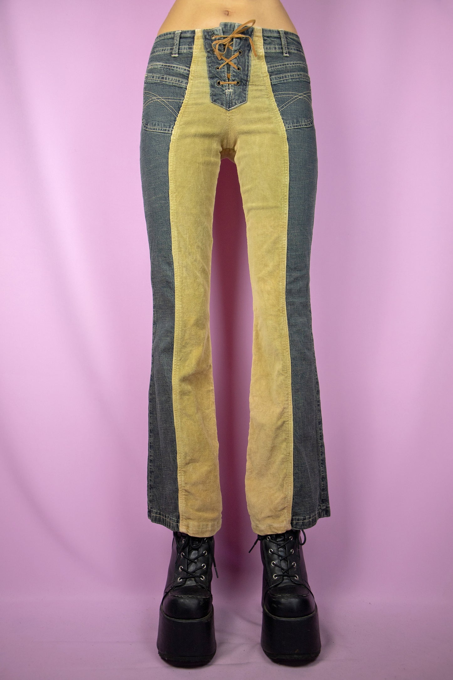The Vintage Y2K Lace-Up Flare Jeans are mid-rise, featuring a unique design with half-denim and half-beige corduroy. These stretchy flared pants come with pockets and a tie-front detail, representing the iconic cyber millennium denim style from the 2000s.