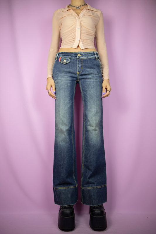 The Vintage Y2K Low Rise Flare Jeans are low-rise, flared wide-leg pants with pockets. These cute cyber millennium dark denim trousers hail from the 2000s.