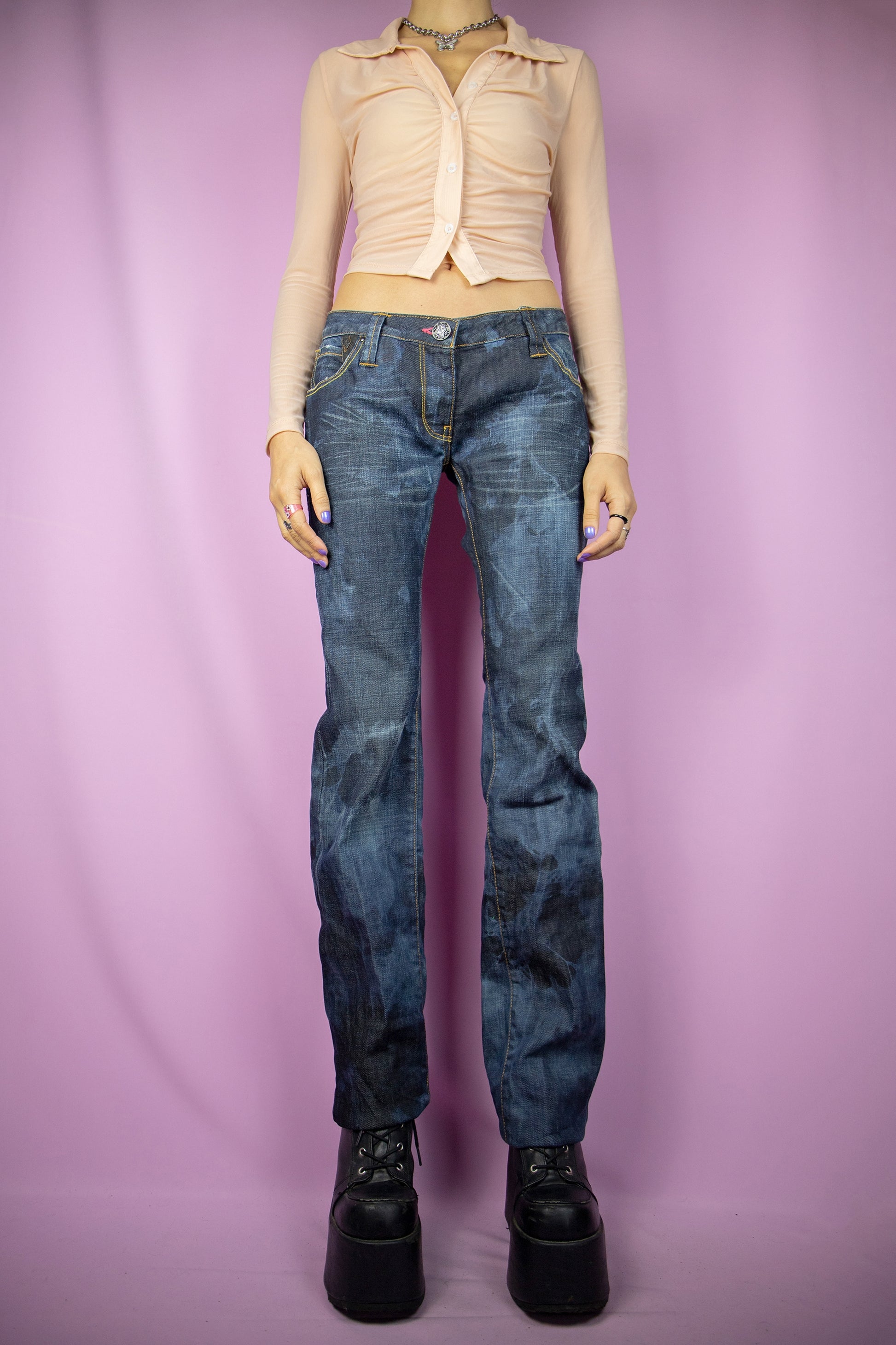 The Y2K Low Rise Bleach Jeans are vintage tie-dye bleached straight pants with pockets, a raw hem, and a subtle stretch. Cyber grunge 2000s dark denim pants.