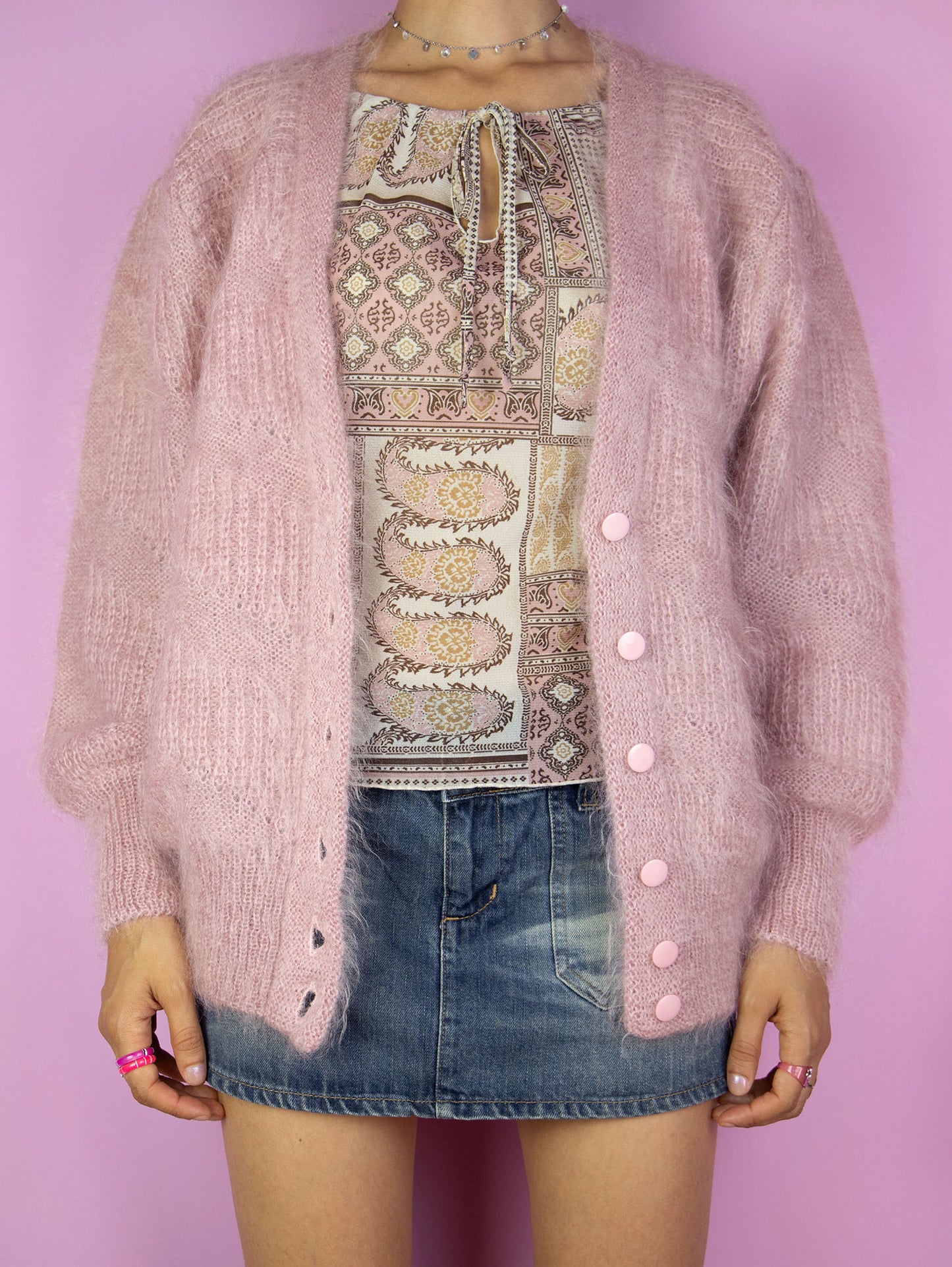 The Vintage 90s Pink Mohair Knit Cardigan is a light, dusty pink mohair blend cardigan with buttons. Romantic boho retro 1990s wool sweater.
