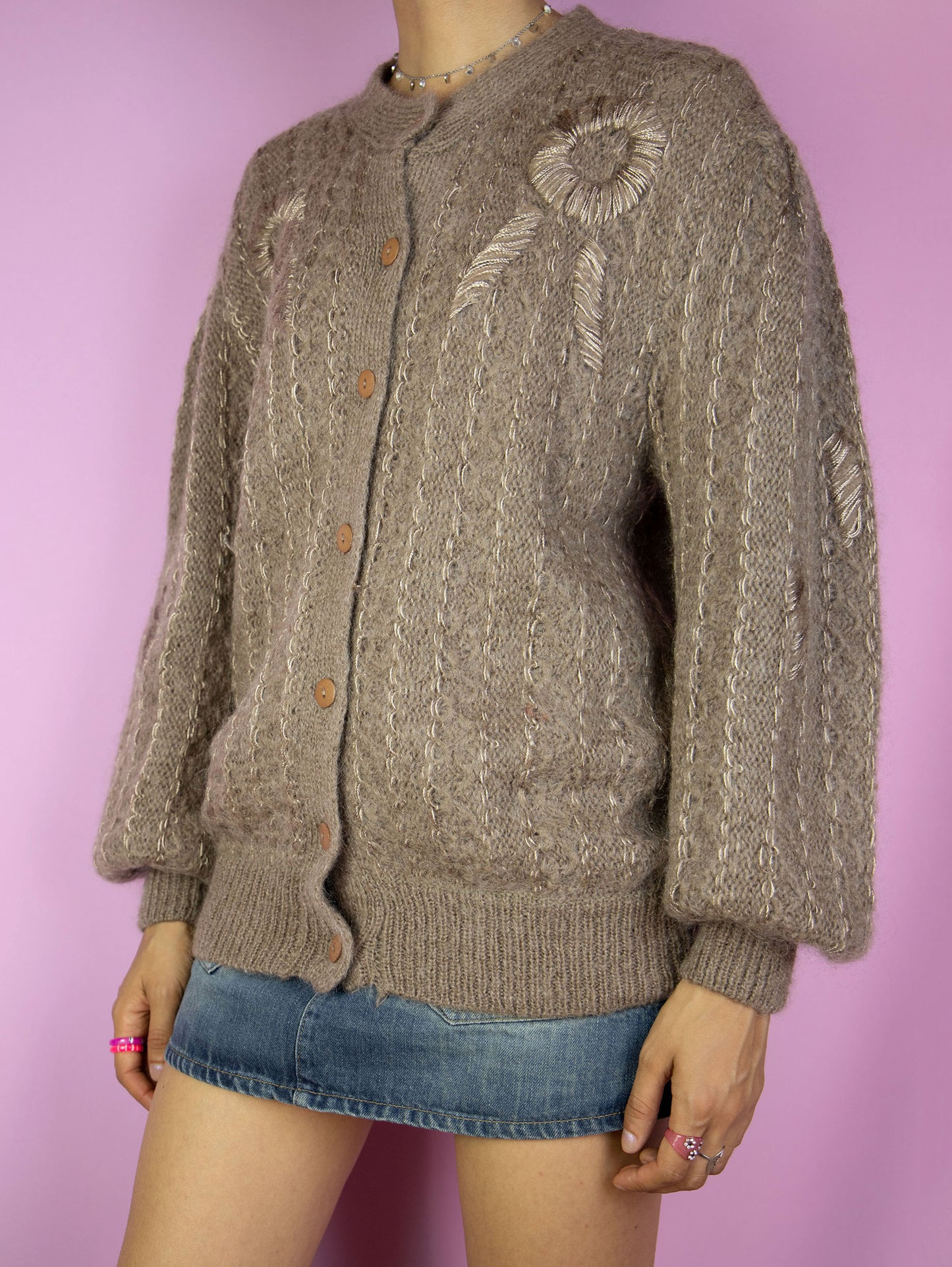 The Vintage 90s Brown Mohair Knit Cardigan is a mohair blend cardigan featuring puff sleeves. Boho retro 1990s wool sweater.