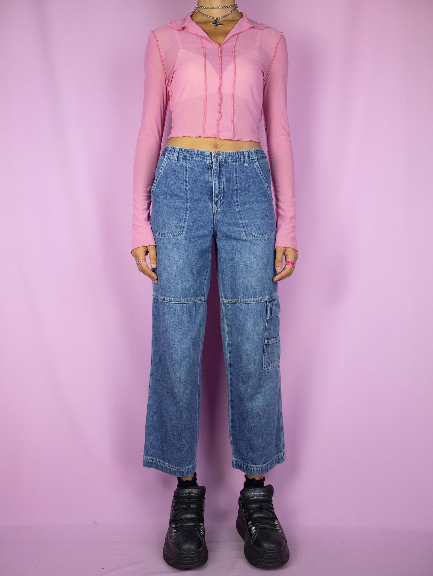 The Y2K Wide Cropped Jeans are vintage 2000s mid-rise cargo ankle denim pants with pockets and zipper closure.