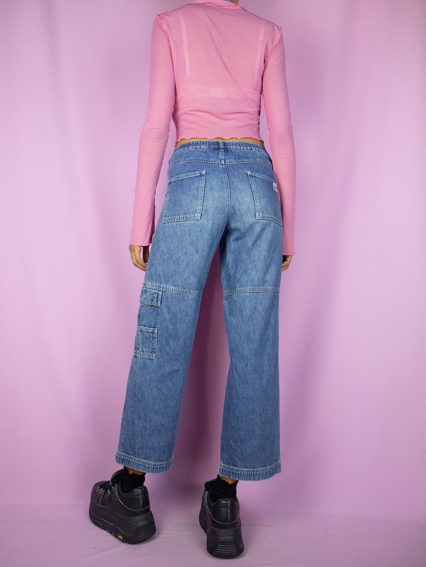 The Y2K Wide Cropped Jeans are vintage 2000s mid-rise cargo ankle denim pants with pockets and zipper closure.