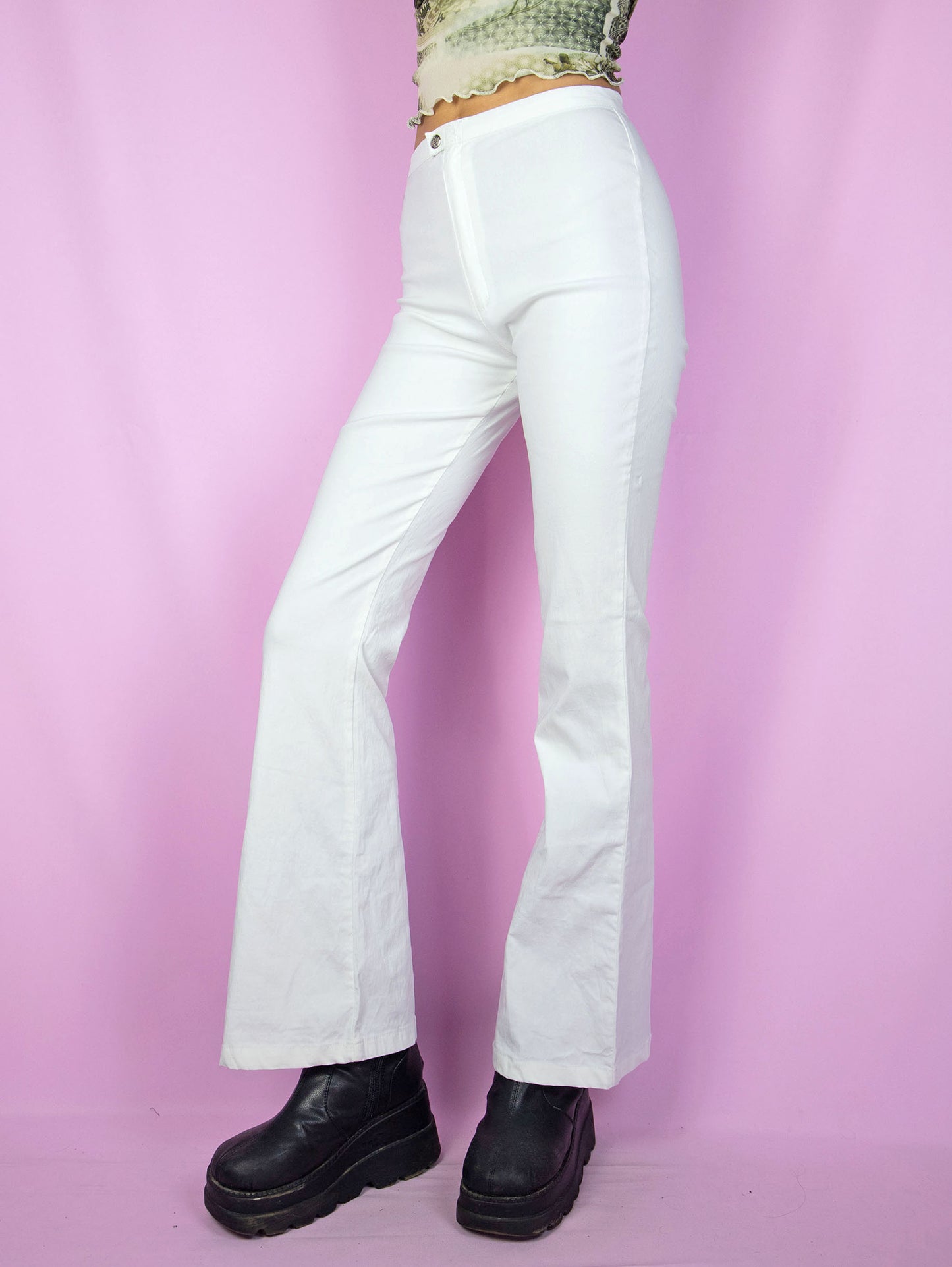 The Y2K White Flare Pants are vintage 2000s stretchy high-waisted pants with a front zipper closure.