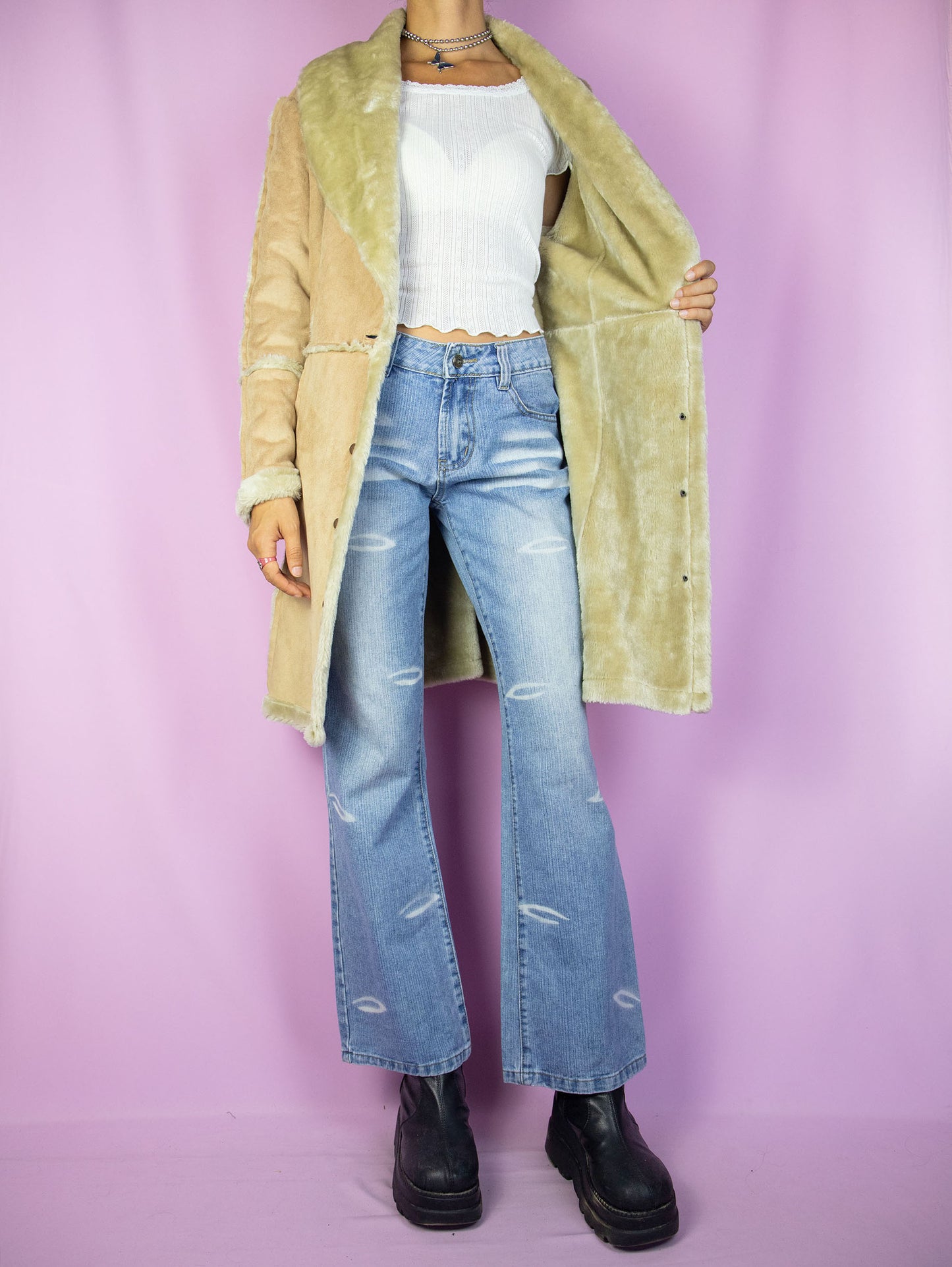 The Y2K Faux Suede Beige Coat is a vintage 2000s winter faux suede statement coat with faux fur lining, v-neck, and snap-button closure.