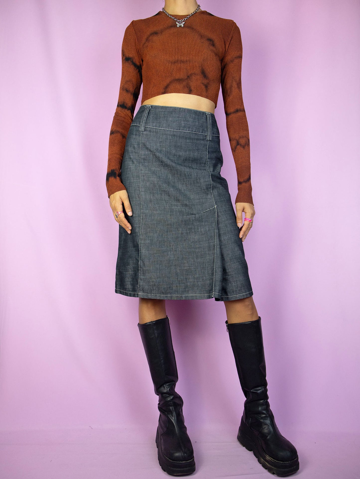 The Y2K Gray Denim Midi Skirt is a vintage skirt with a back zipper closure and front pleat detail. Cyber grunge 2000s subversive skirt.