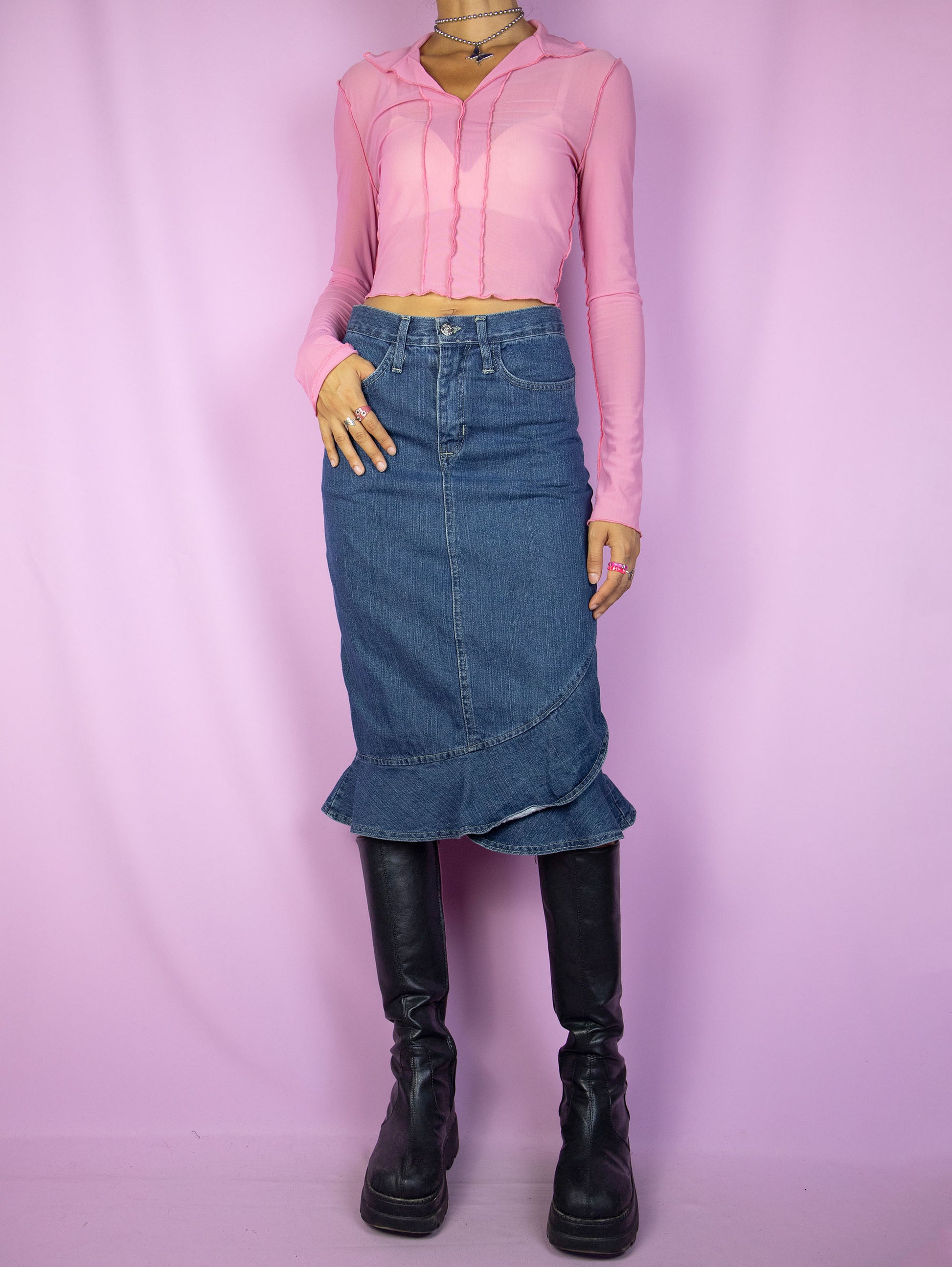 The Y2K Trumpet Denim Midi Skirt is a vintage 2000s jean skirt with a ruffled hem, back slit, pockets and zipper closure.