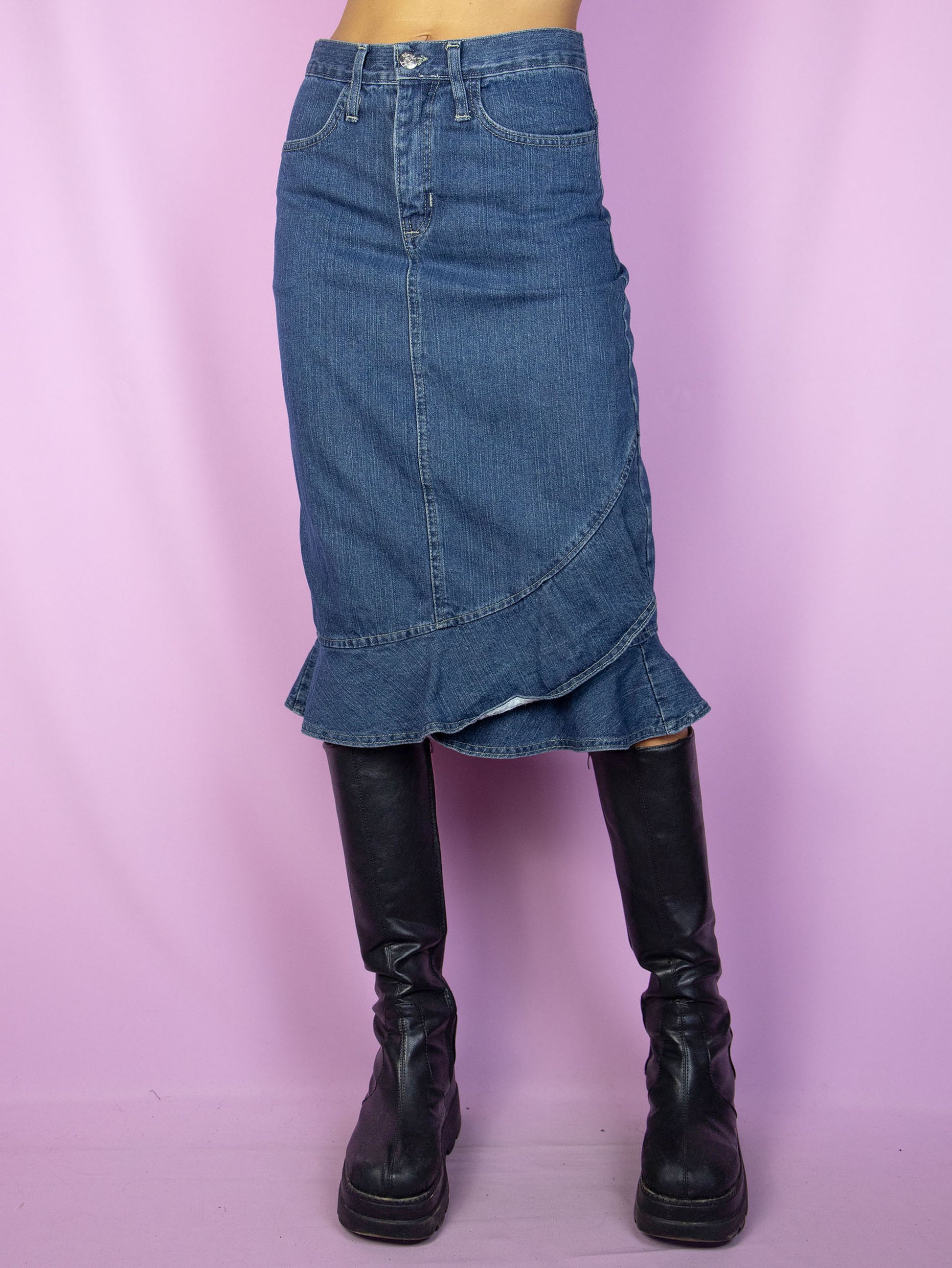 The Y2K Trumpet Denim Midi Skirt is a vintage 2000s jean skirt with a ruffled hem, back slit, pockets and zipper closure.