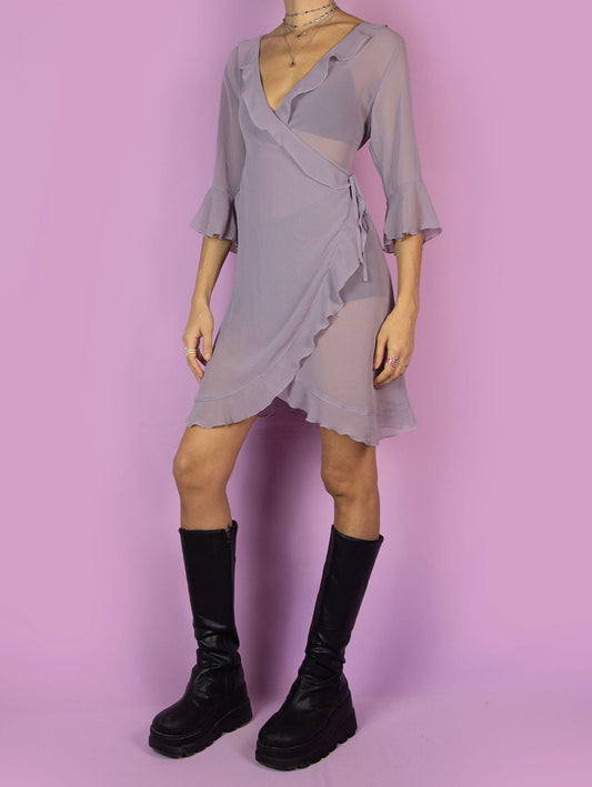 The Y2K Purple Sheer Duster Robe is a vintage dusty purple semi-transparent robe with ruffles, wrapped and tied at the side. Romantic coquette 2000s peignoir jacket.